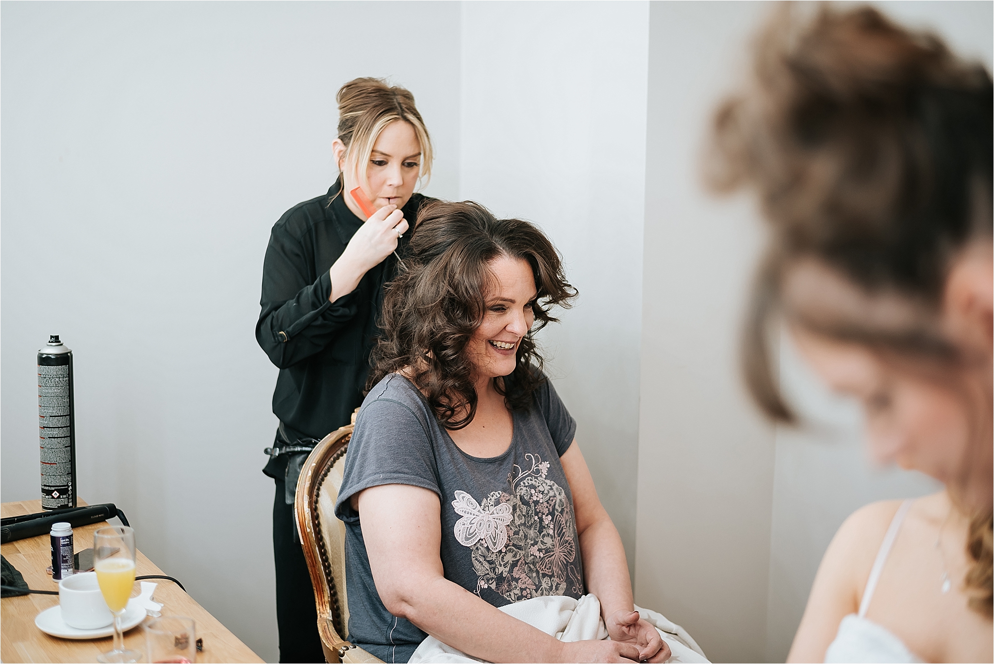 bride having her hair done in the bridal suite 