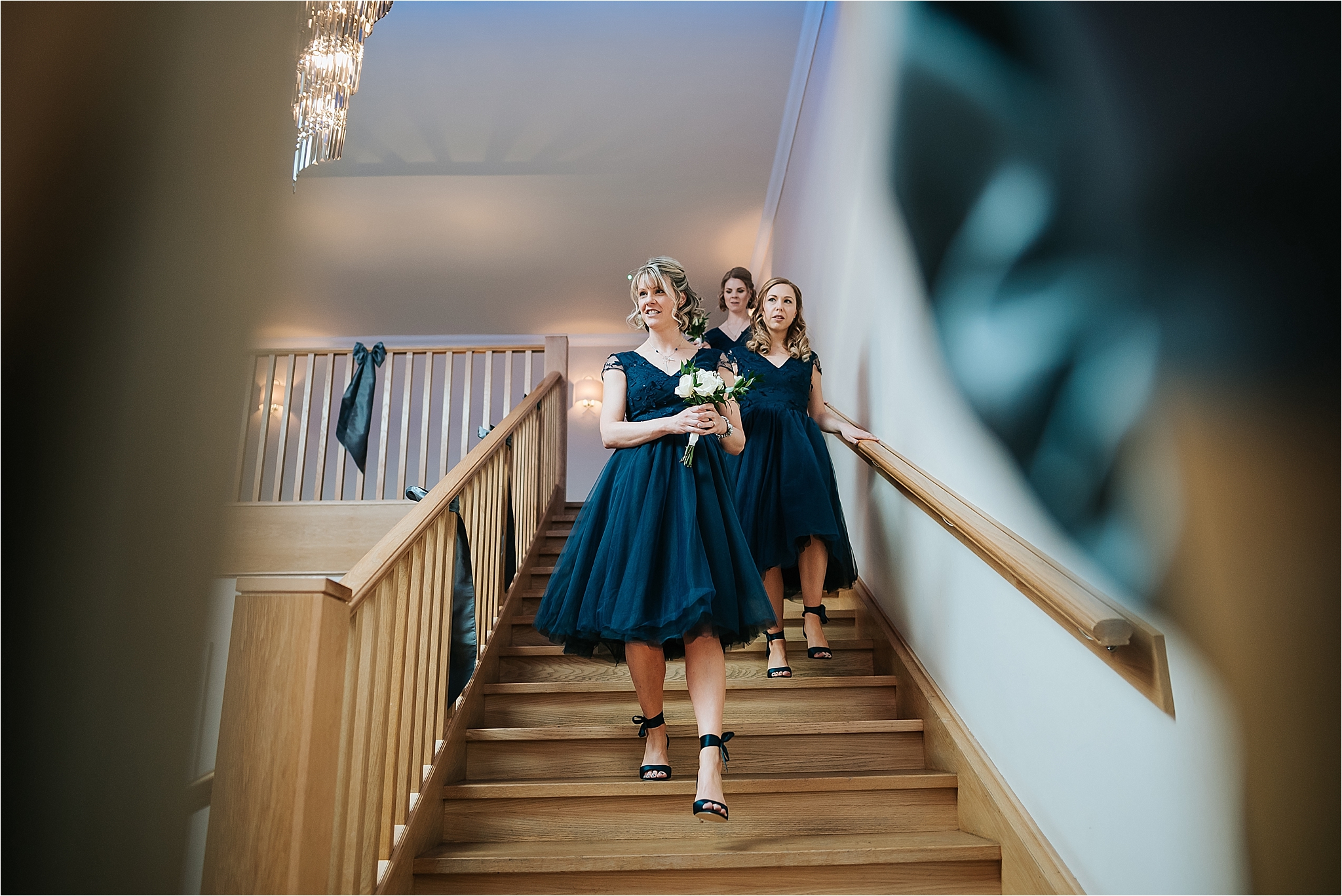 bridesmaids walk down steps 