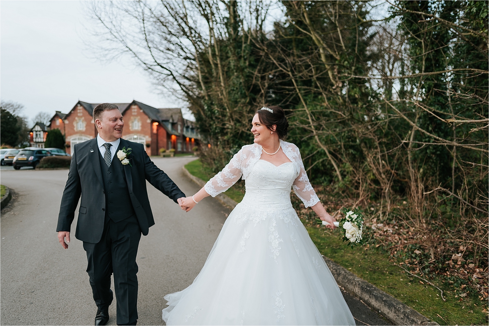 bride and groom walking along outside the villa 