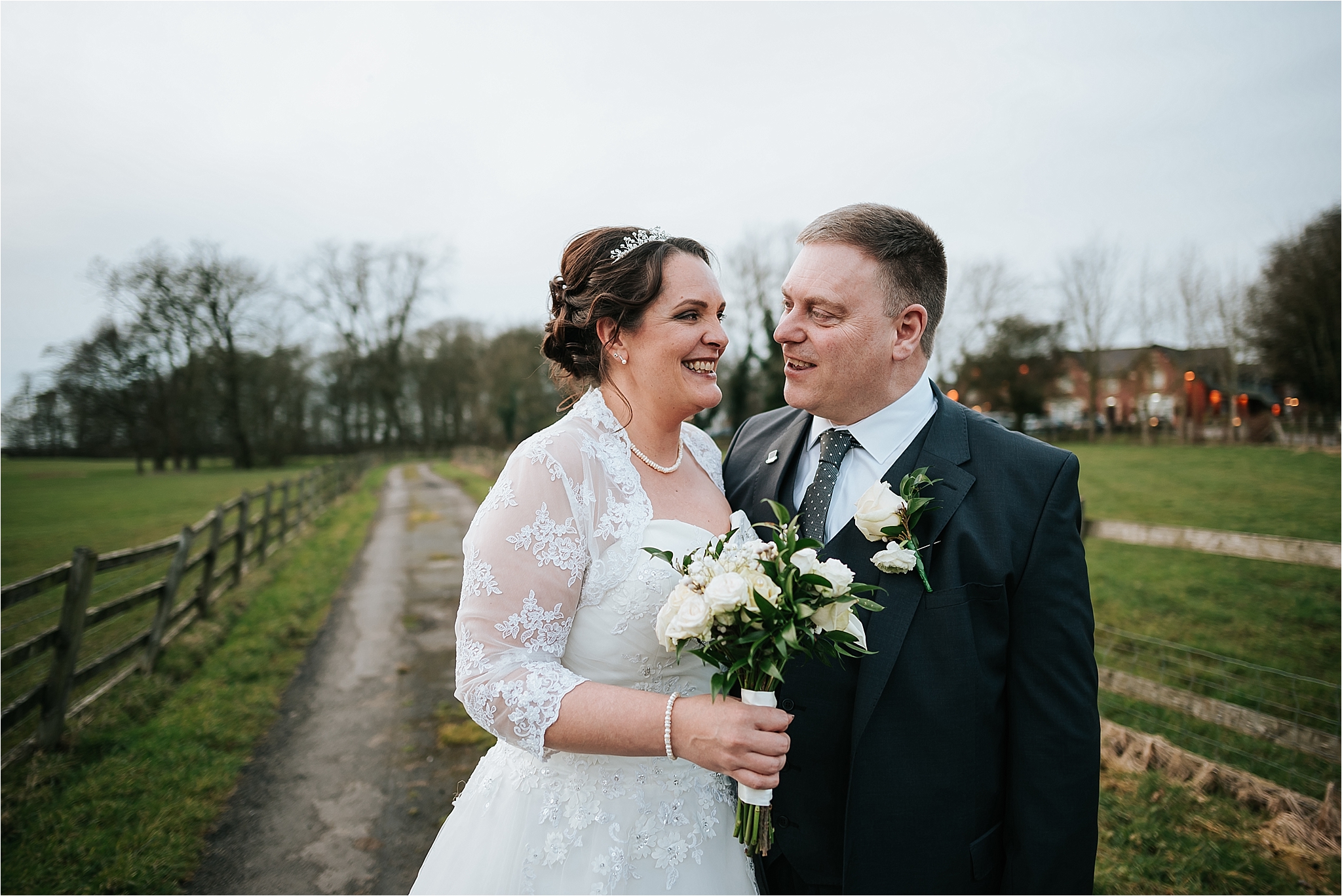 bride and groom in field outside the villa wrea green