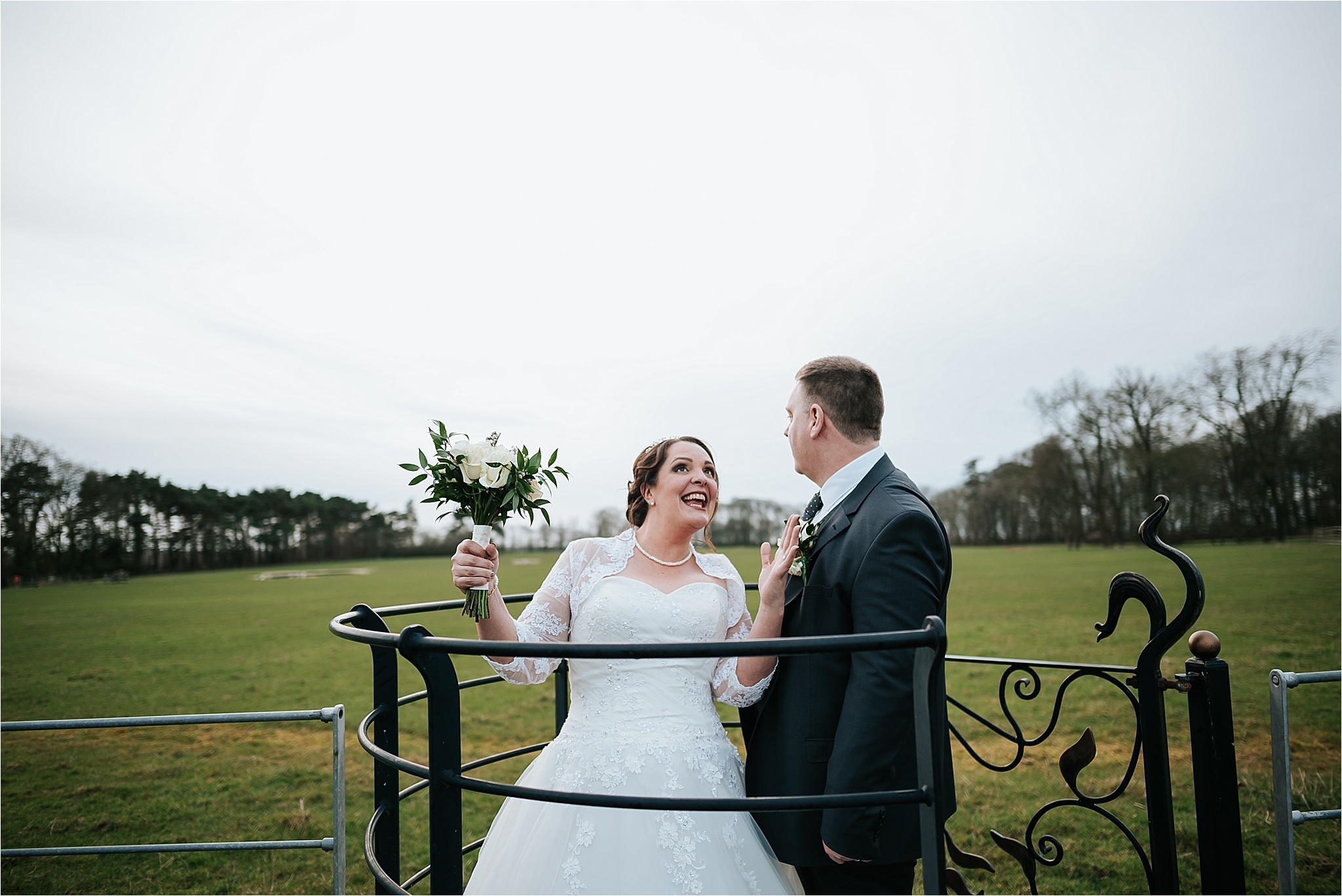 couple posing in the kissing gate at the villa 