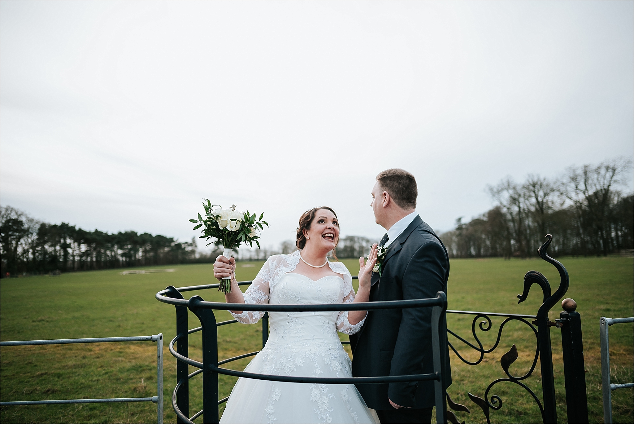 couple posing in the kissing gate at the villa