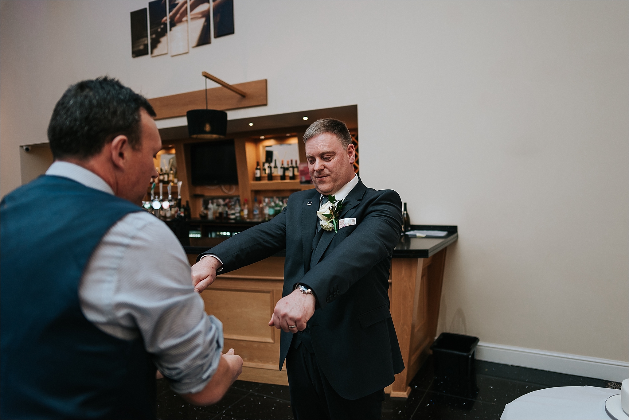 magician entertains groom at a wedding