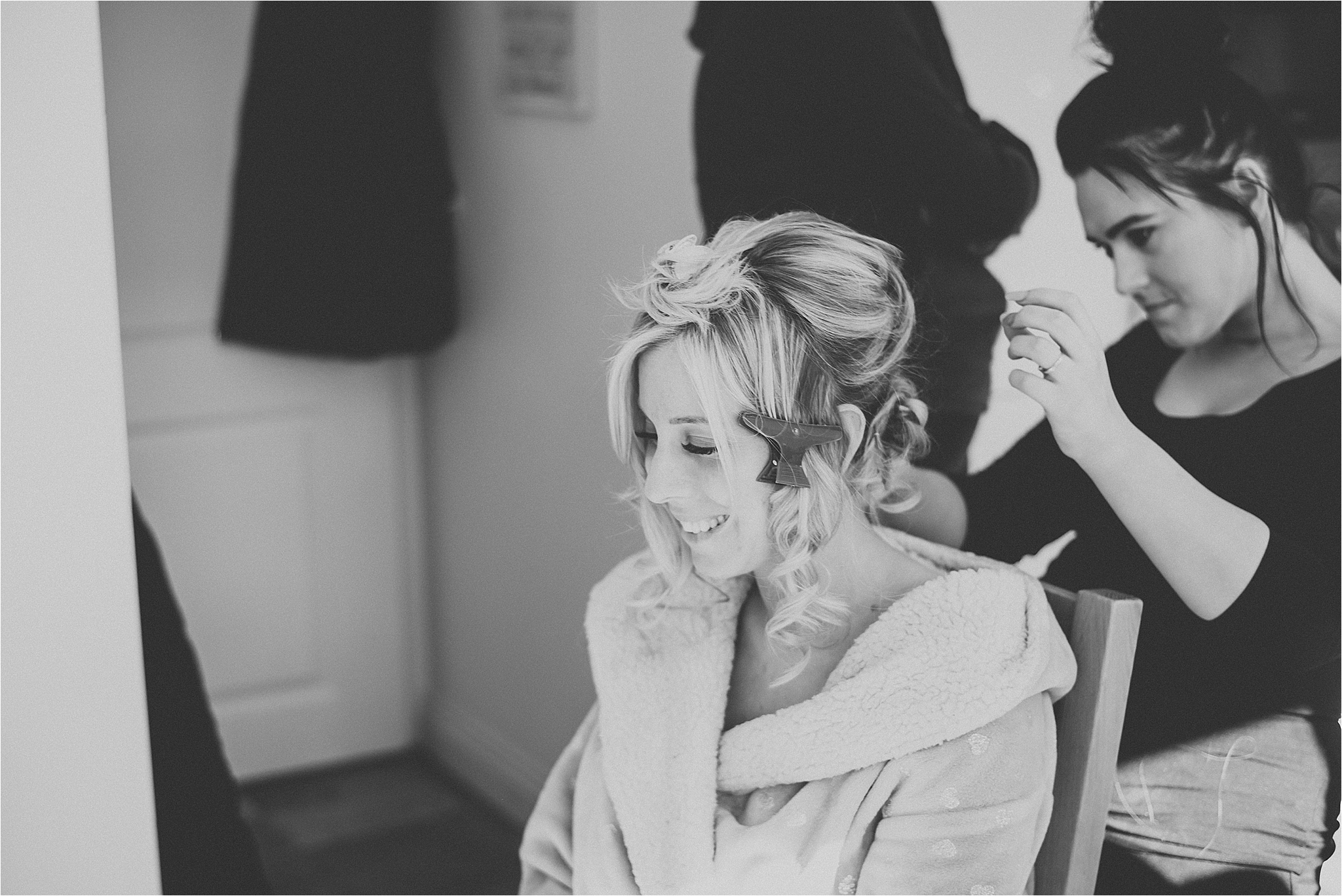 bride getting hair and makeup done before wedding