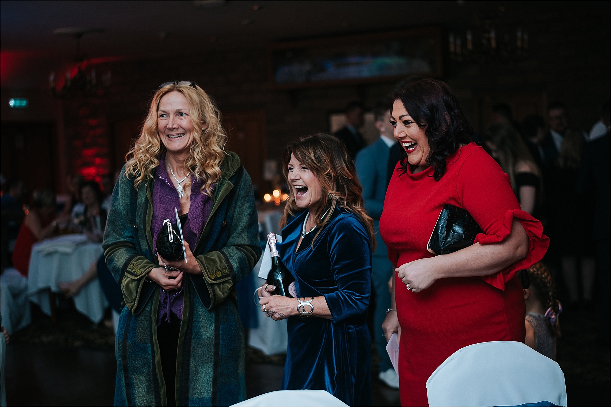 ladies looking excited to see bride at wedding
