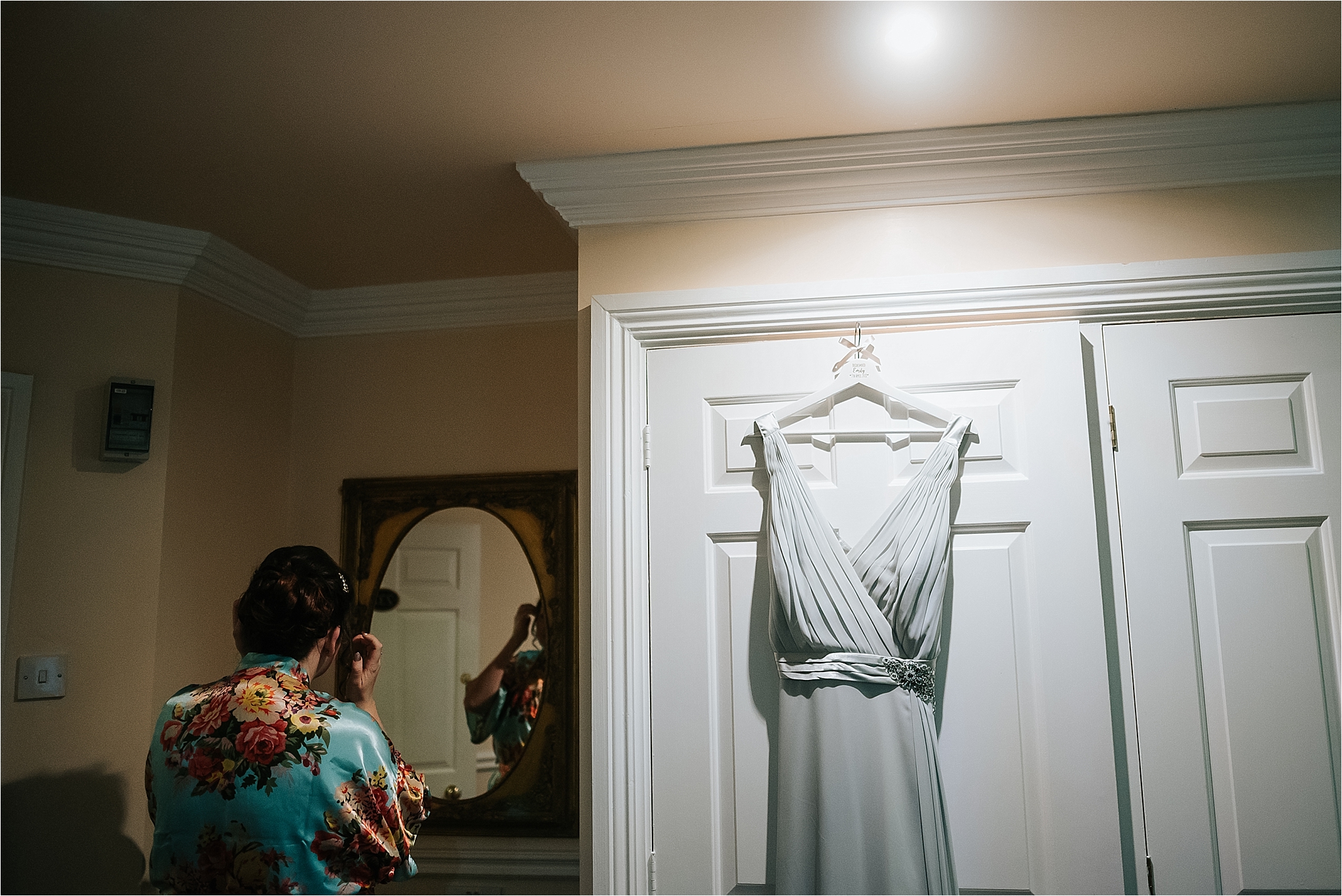 bridesmaid dress hangs in bridal suite