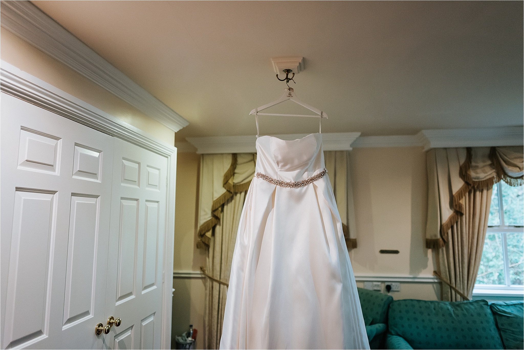 wedding dress from wed2be hangs up