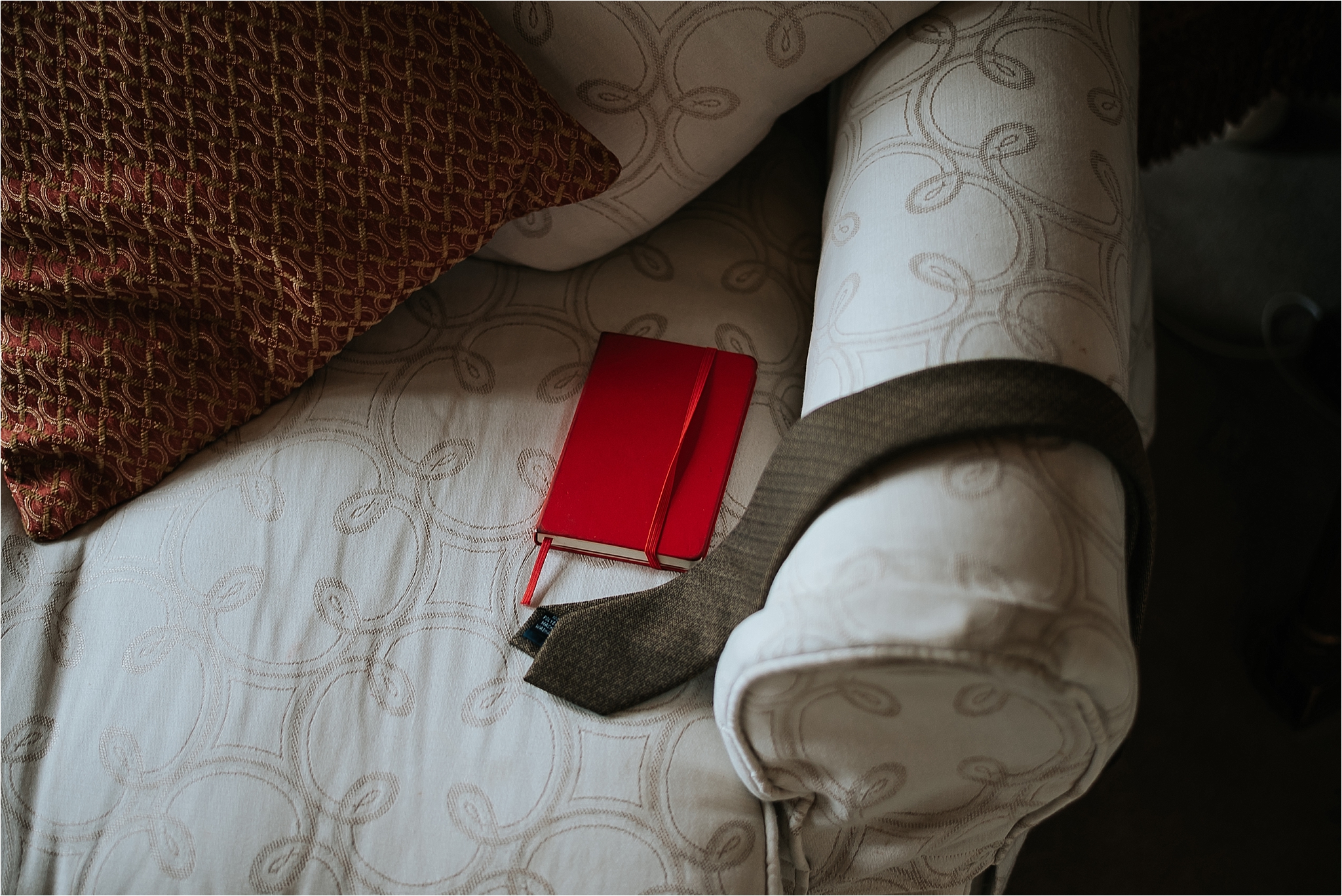 grooms brown tie and note book 