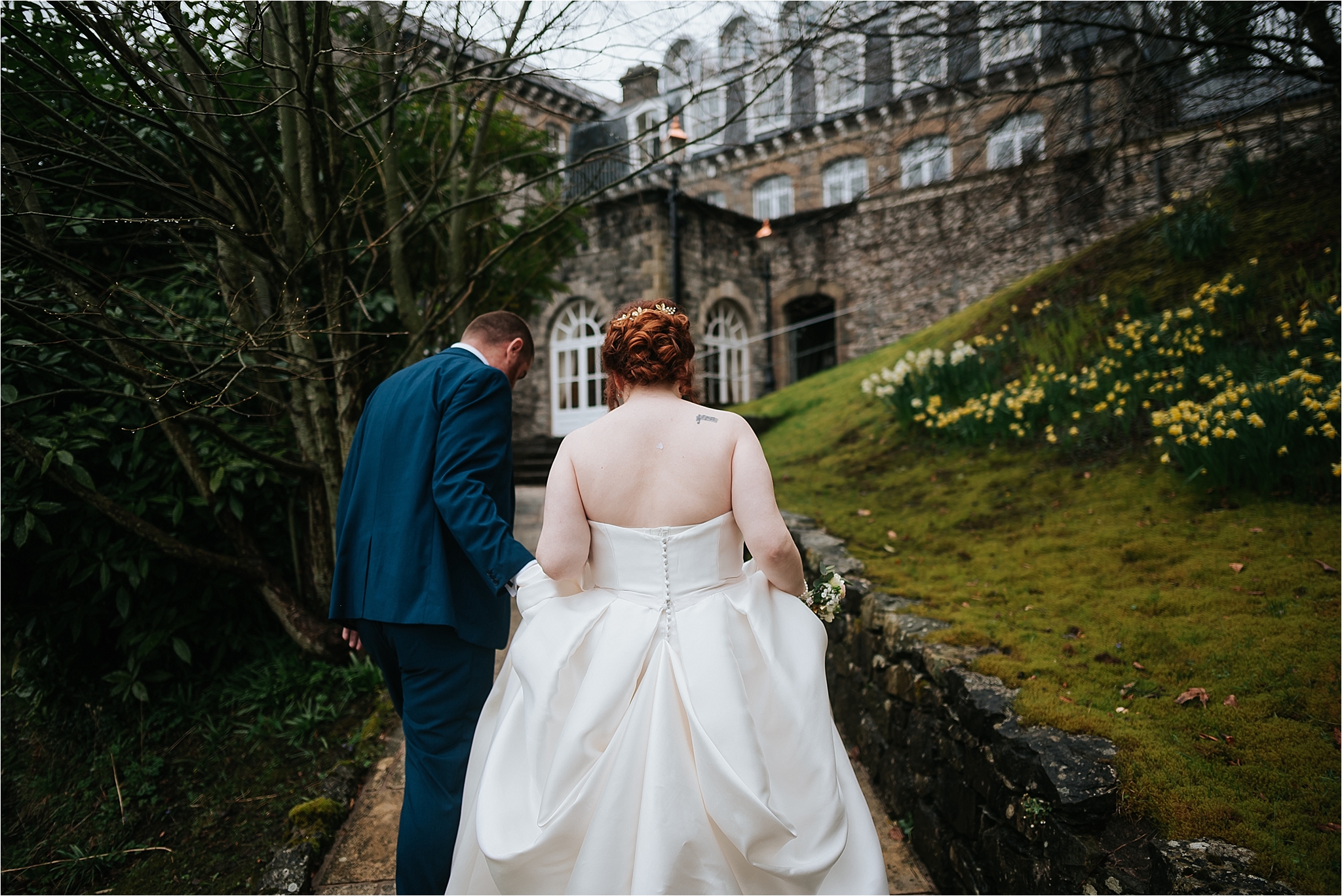 bride and groom walk towards grange hotel 