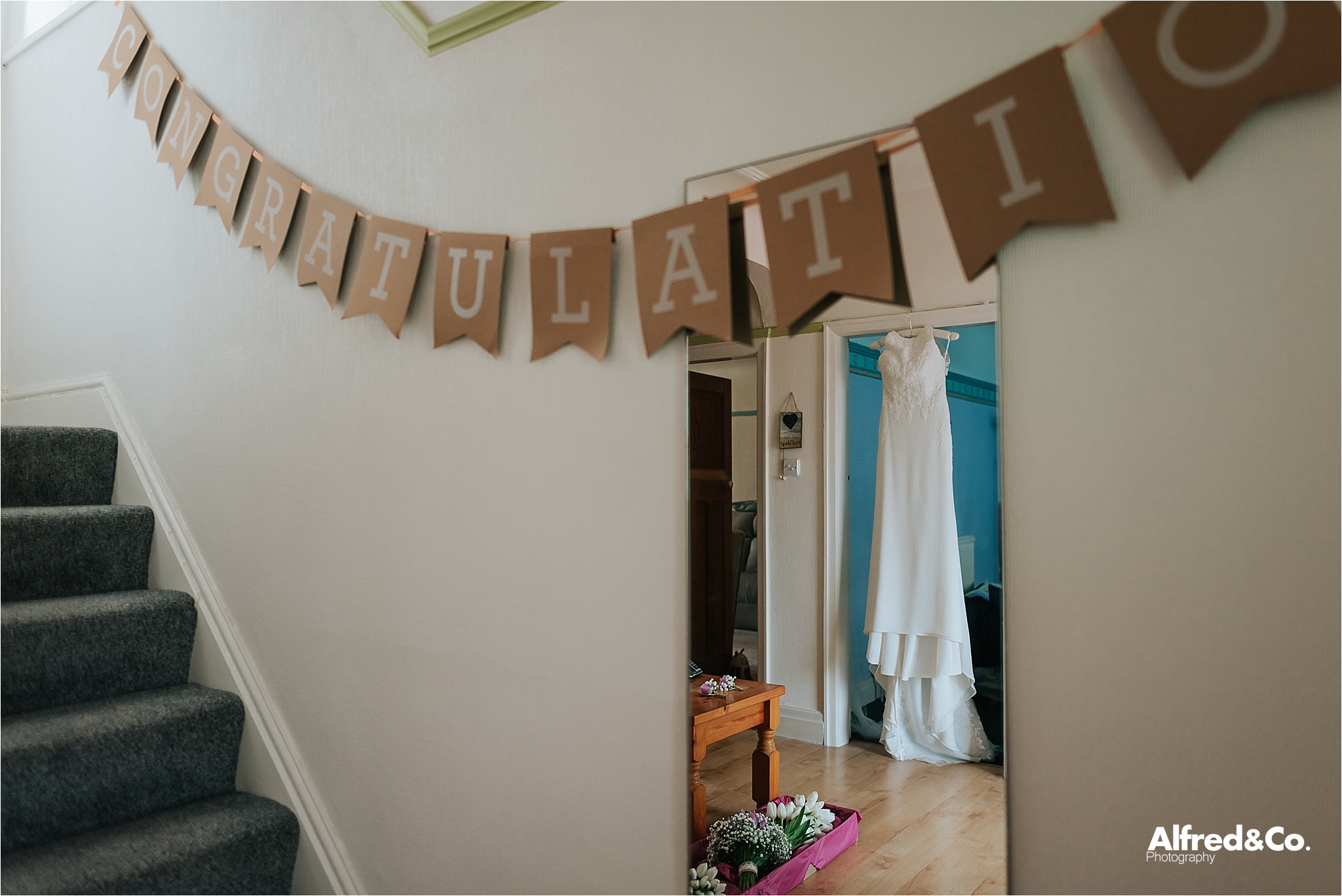 wedding dress hanging up in mirror