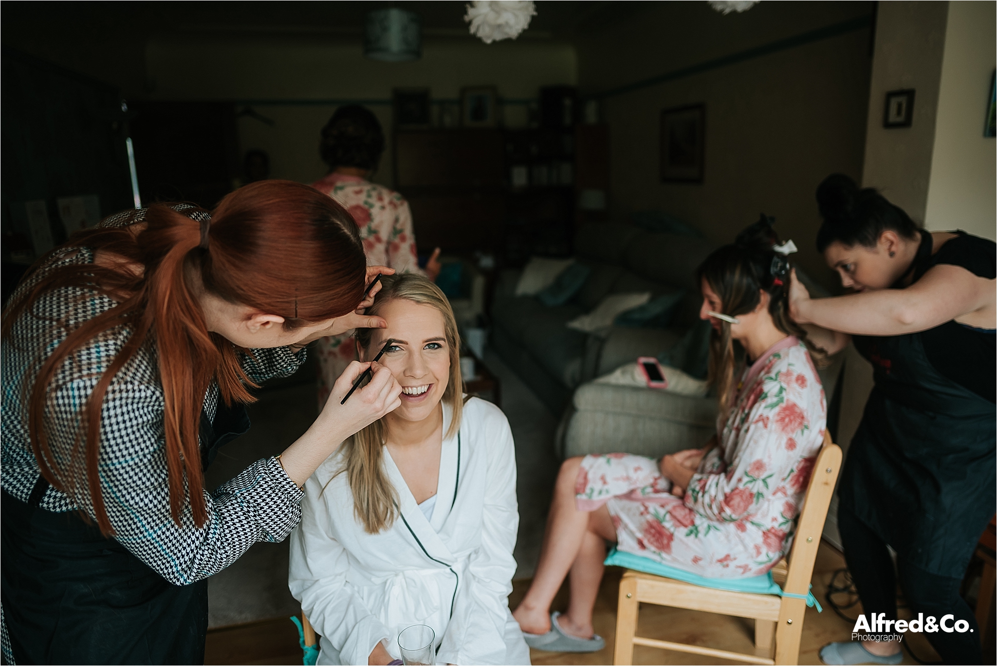 bride getting her make up on before wedding 
