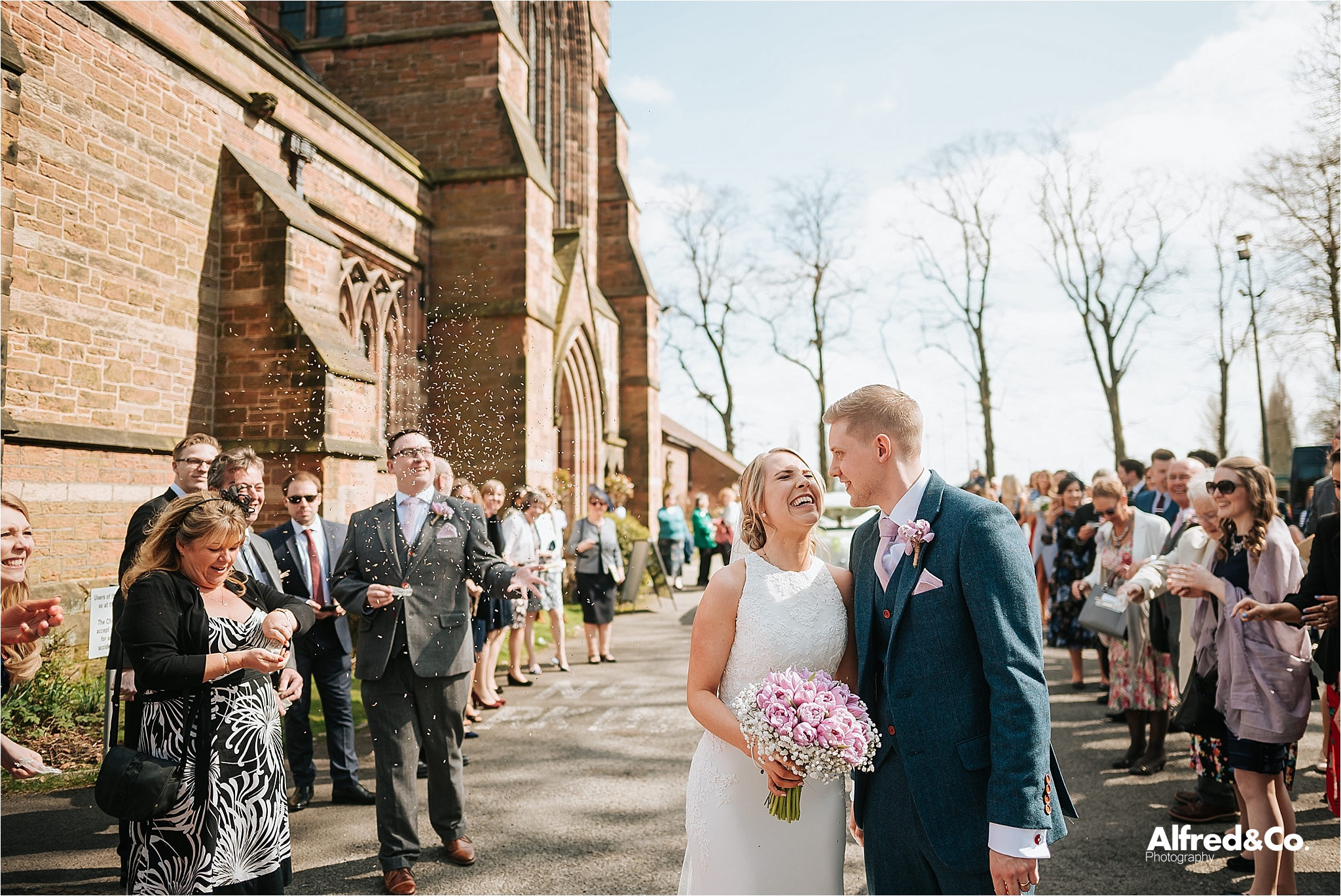 bride and groom in confetti walk way