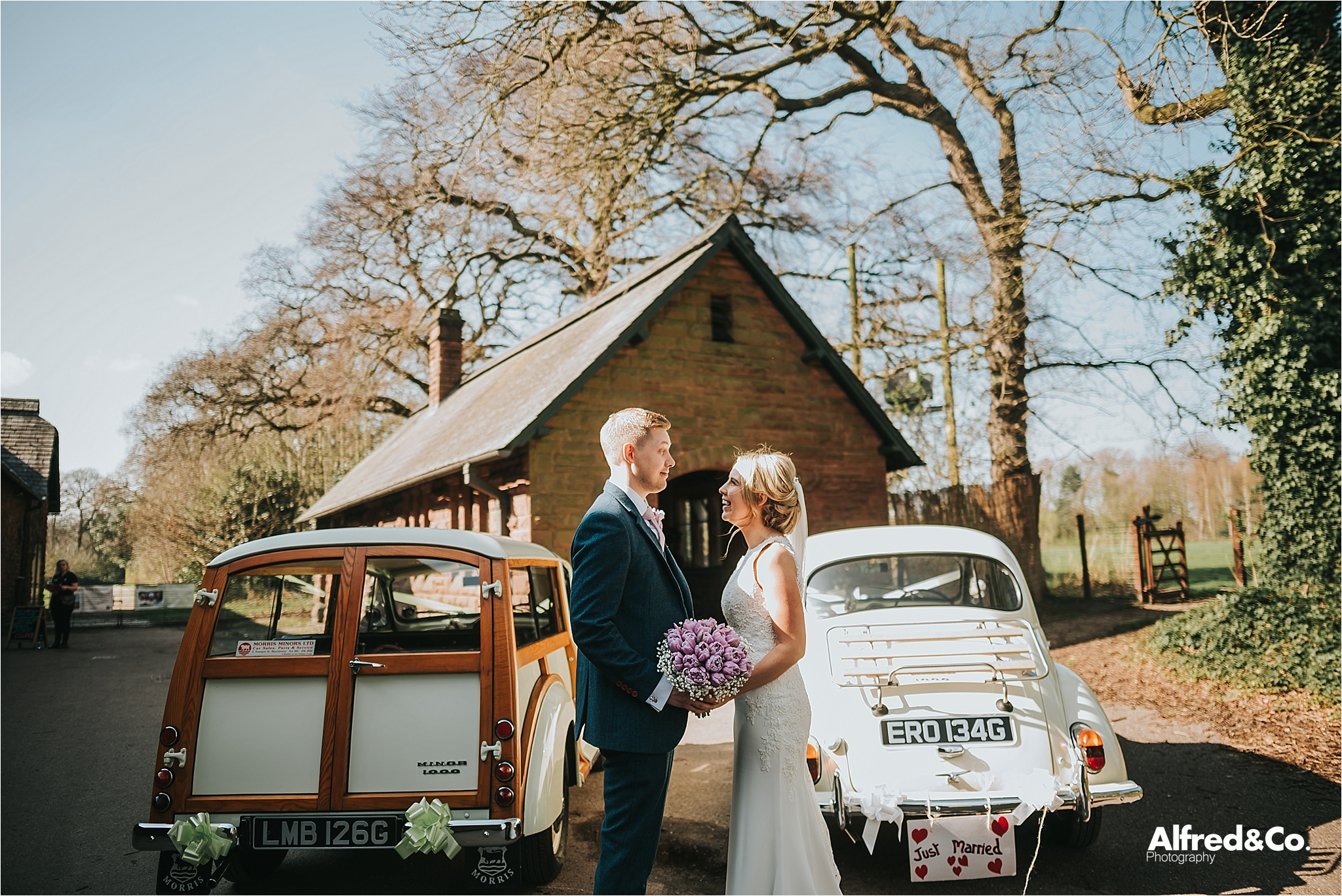 bride and groom with classic cars 