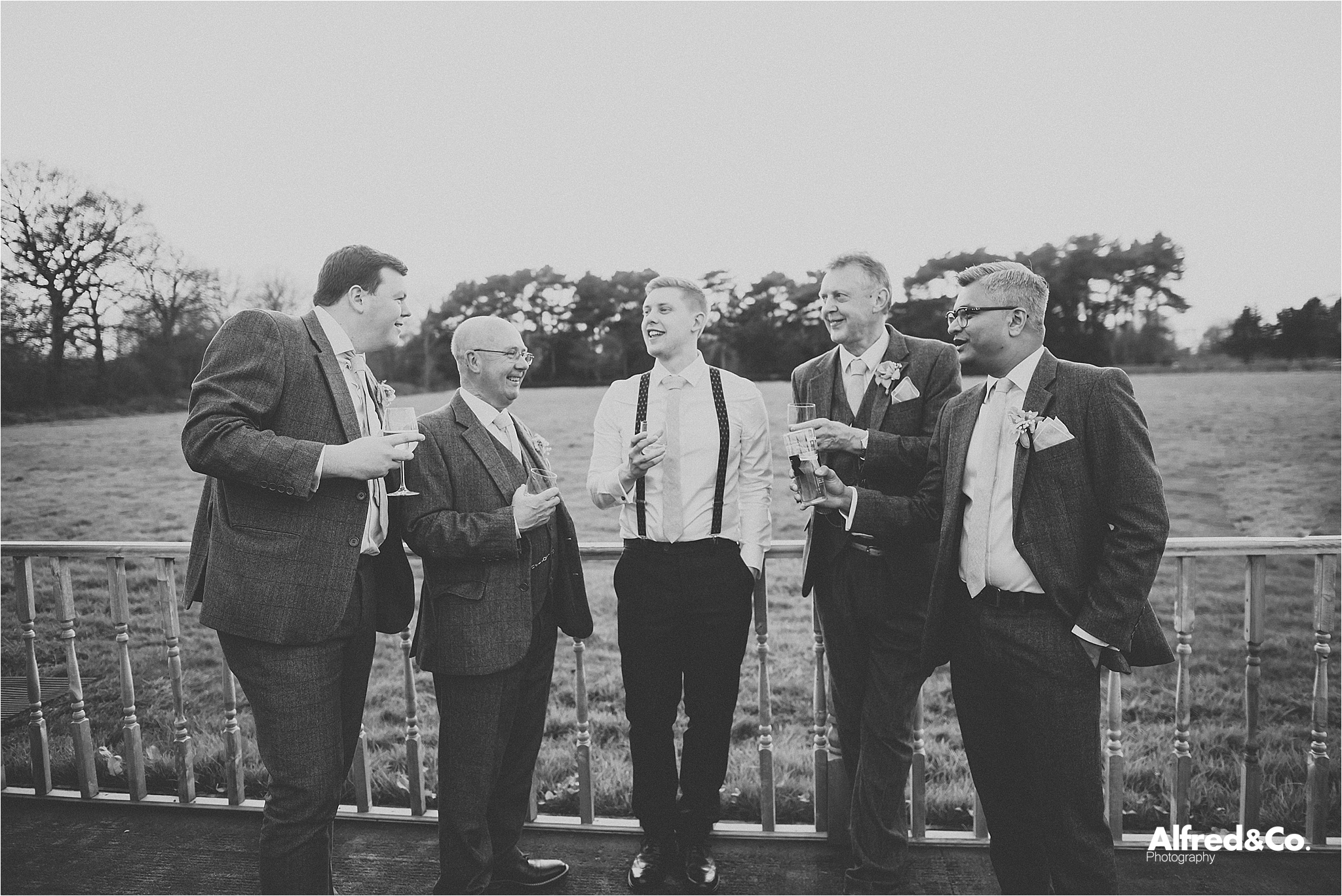 groomsmen enjoying a drink at wedding 