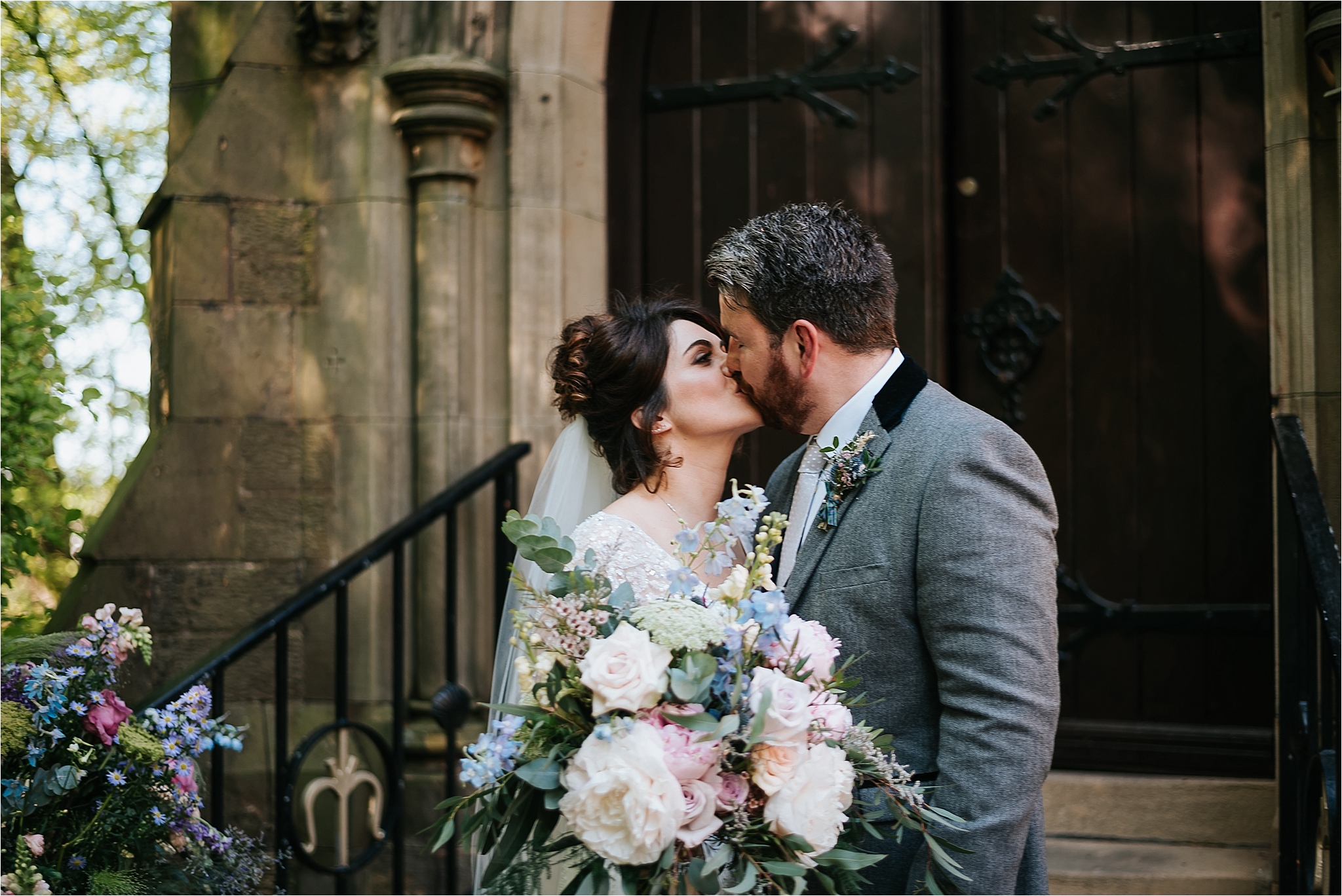 bride and groom kiss outside church