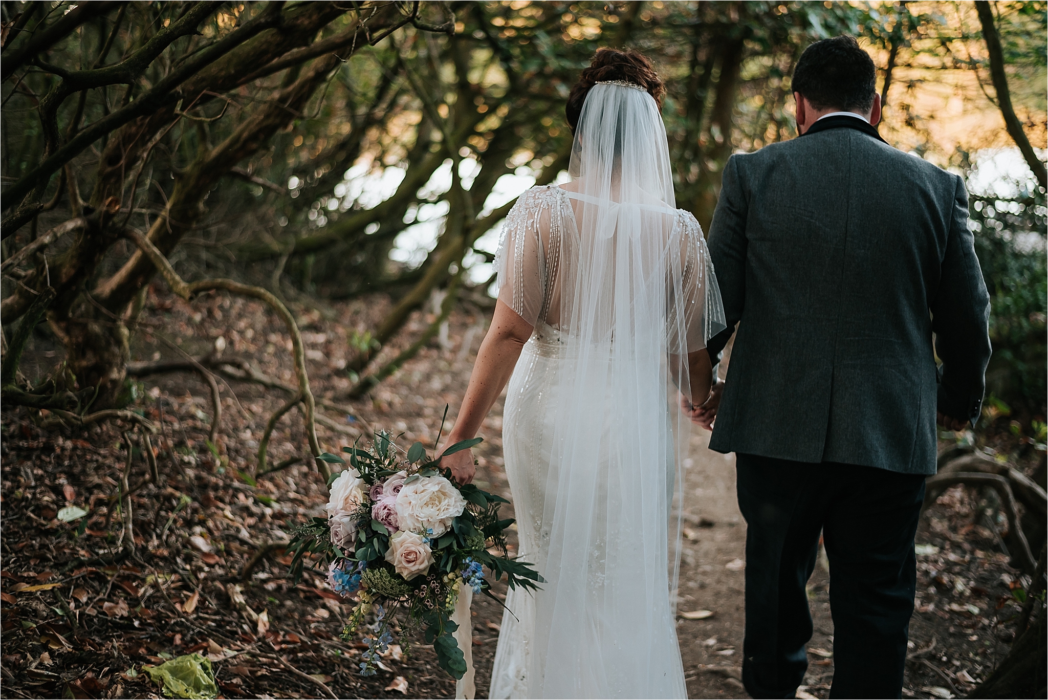 bride and groom walk to lake at wyresdale park