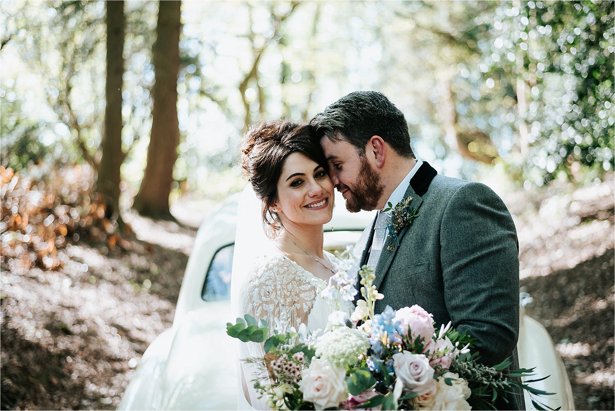 bride and groom in front of car at wyresdale park