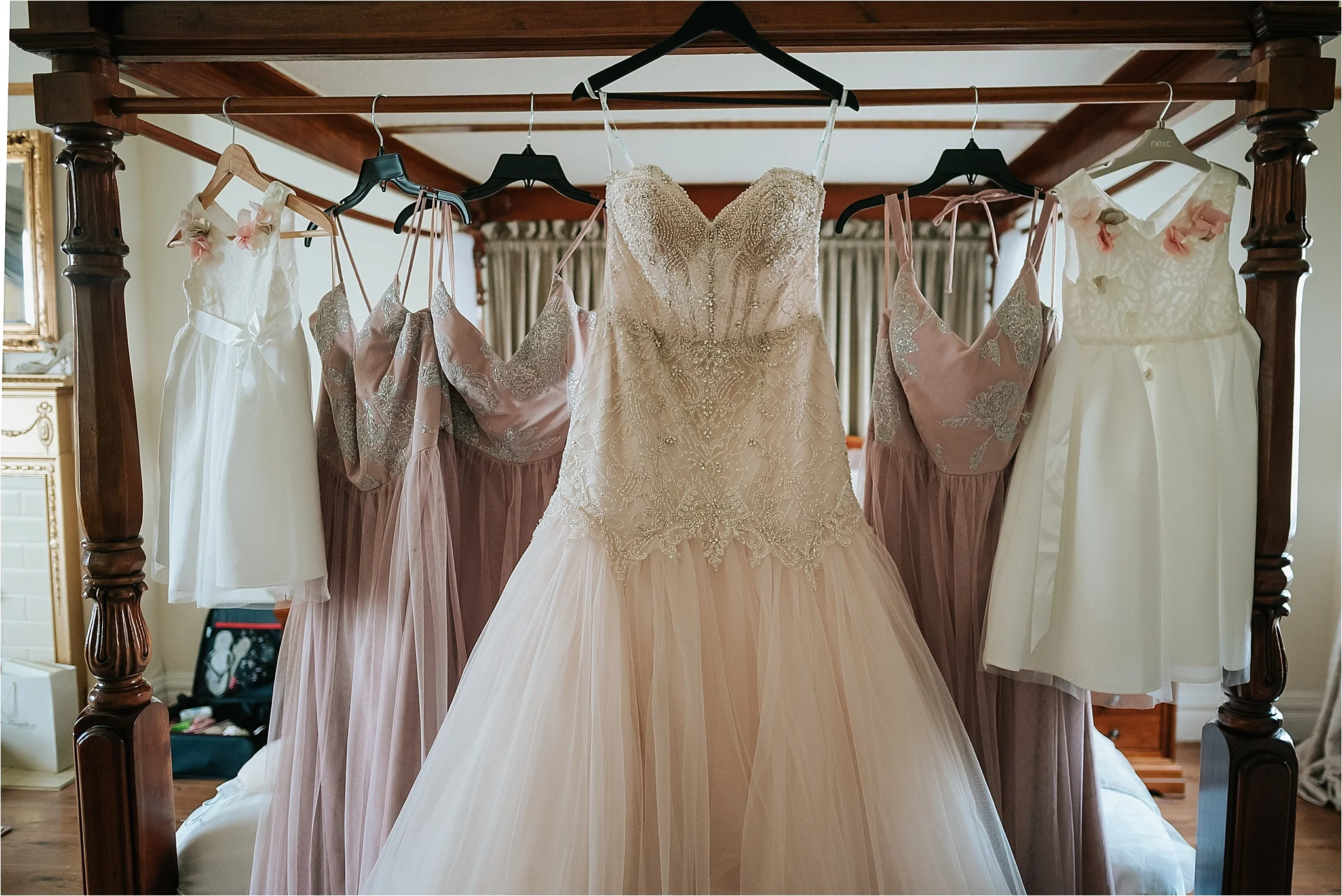 wedding dress hung on bed
