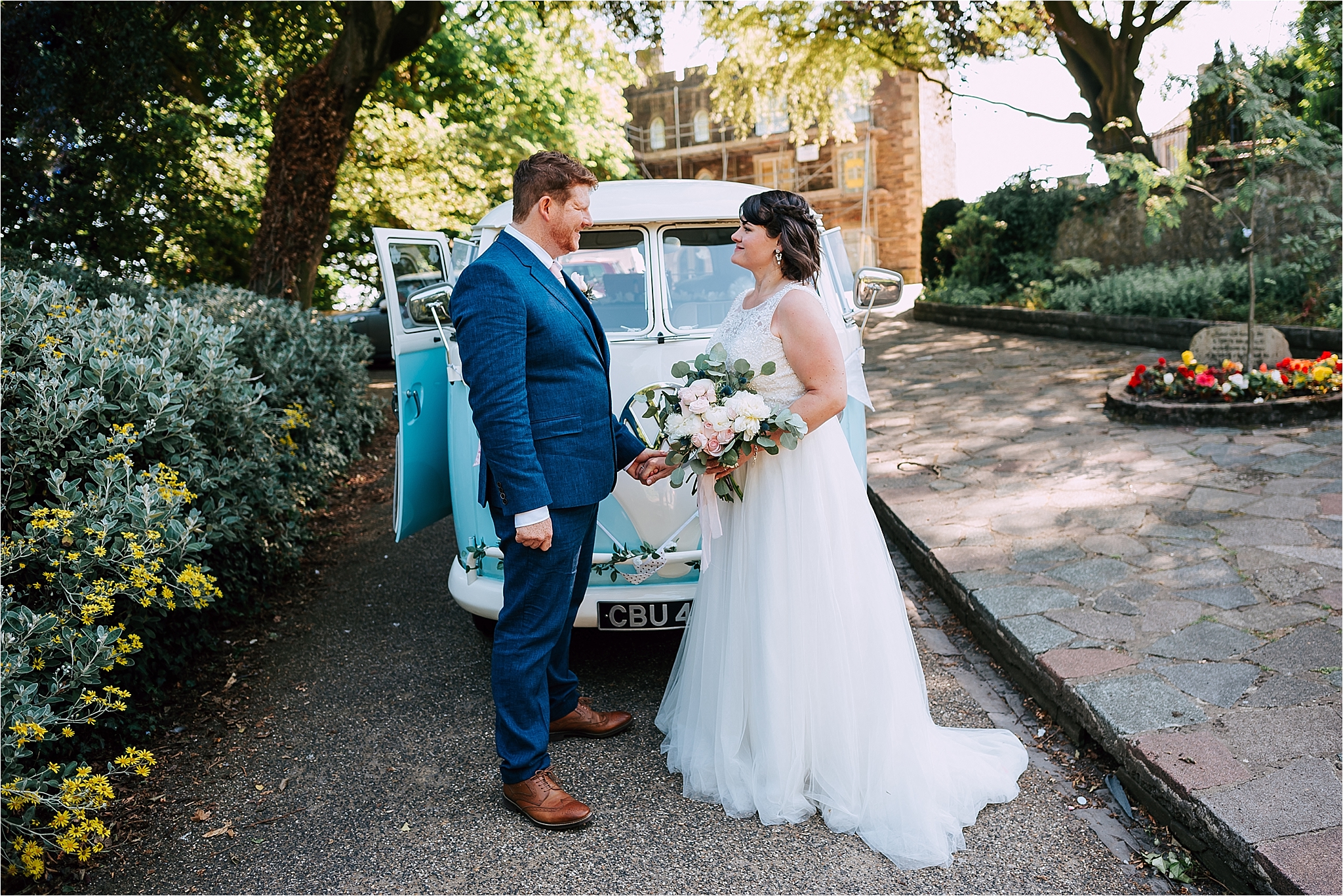 Bride and groom in front of VW camper van at clitheroe castle wedding