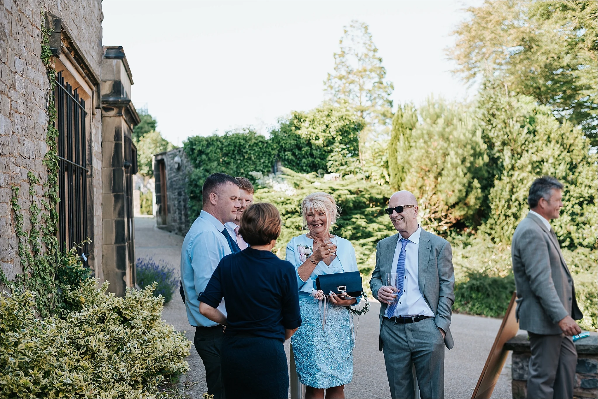 Guests enjoying a summer wedding outside the atrium cafe