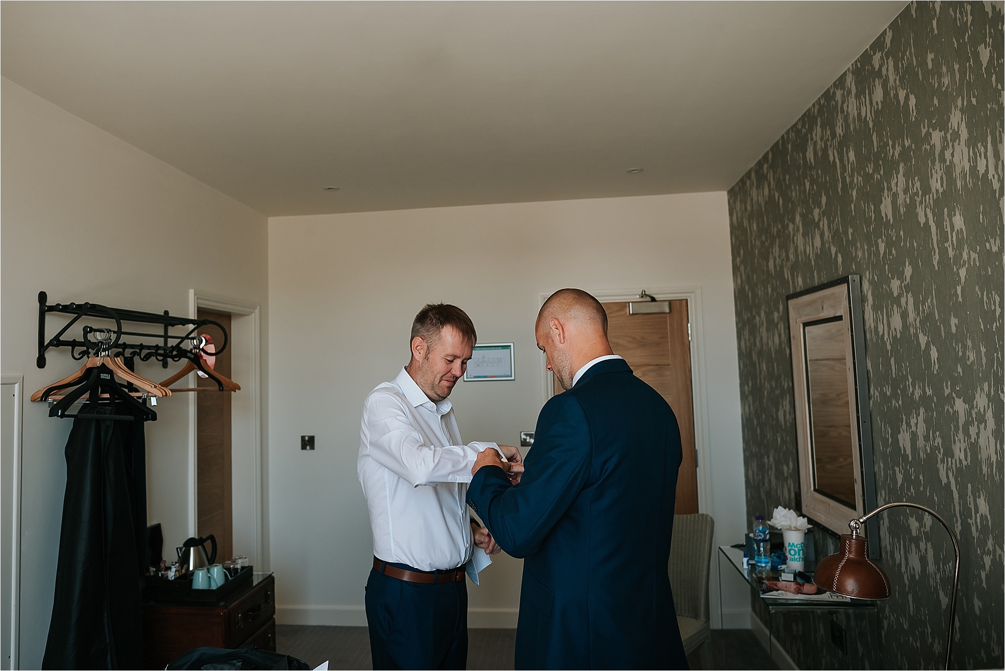 Groom getting ready before wedding at holmes mill 