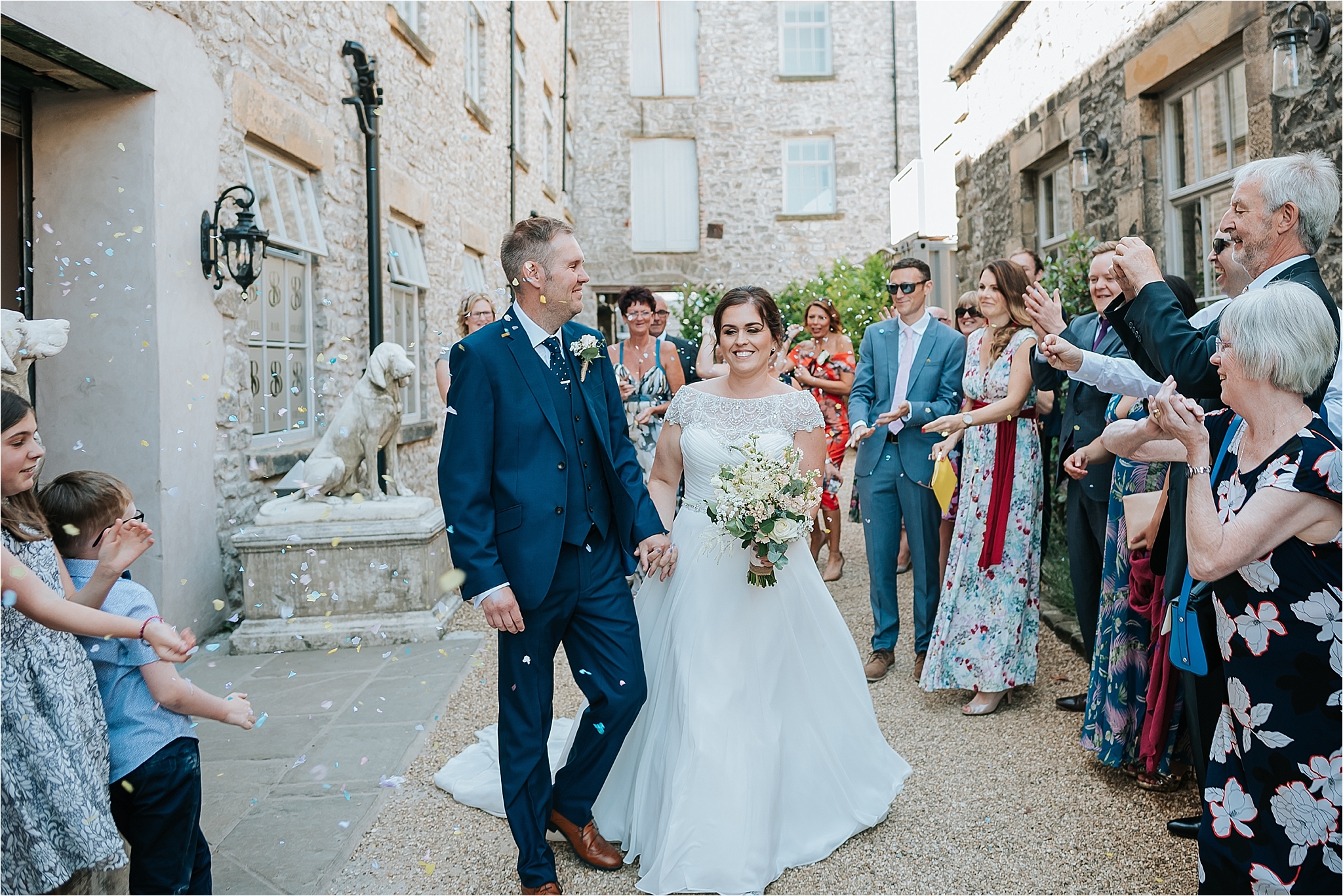 Bride and Groom with confetti at the spinning block at holmes mill 