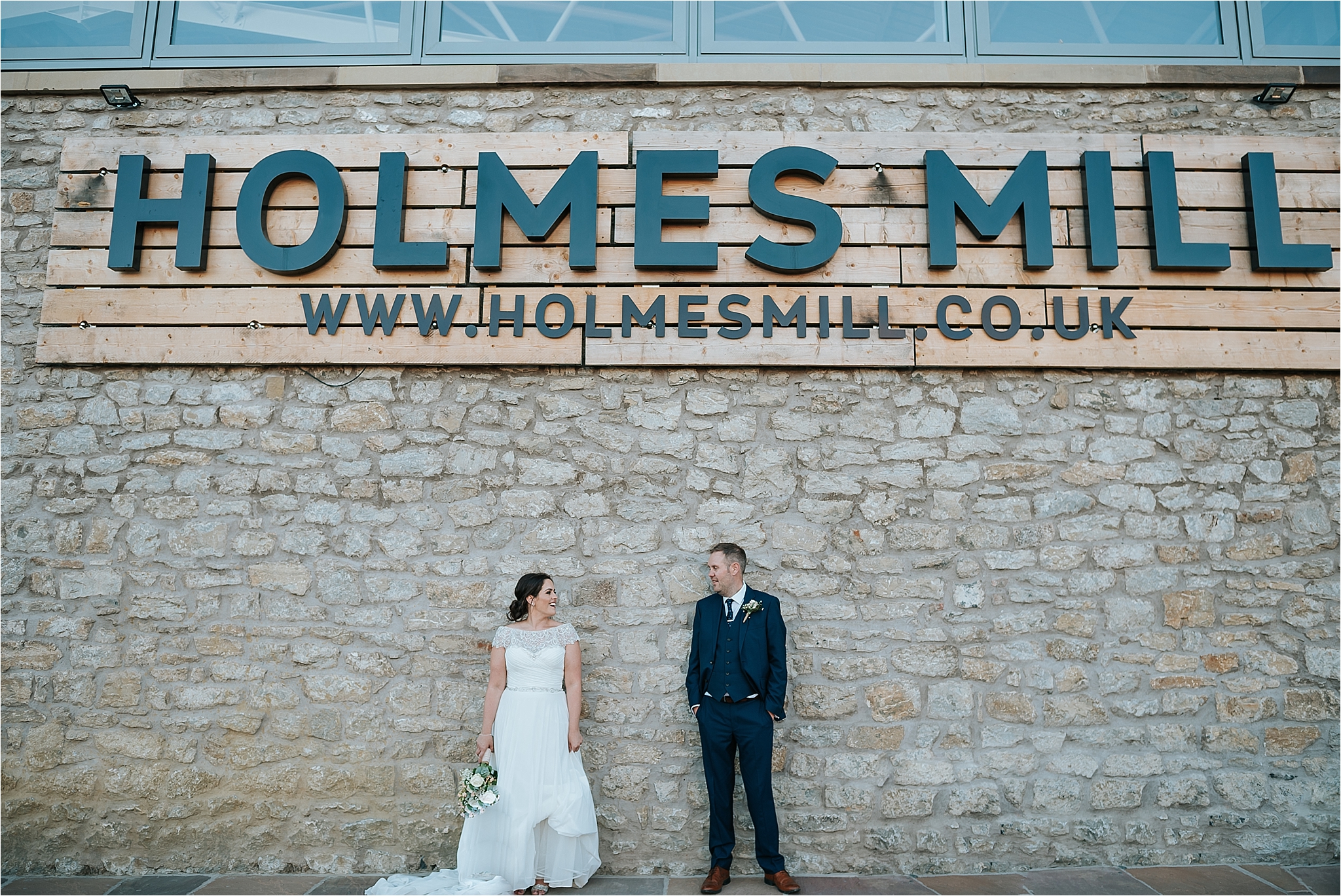 bride and groom outside holmes mill