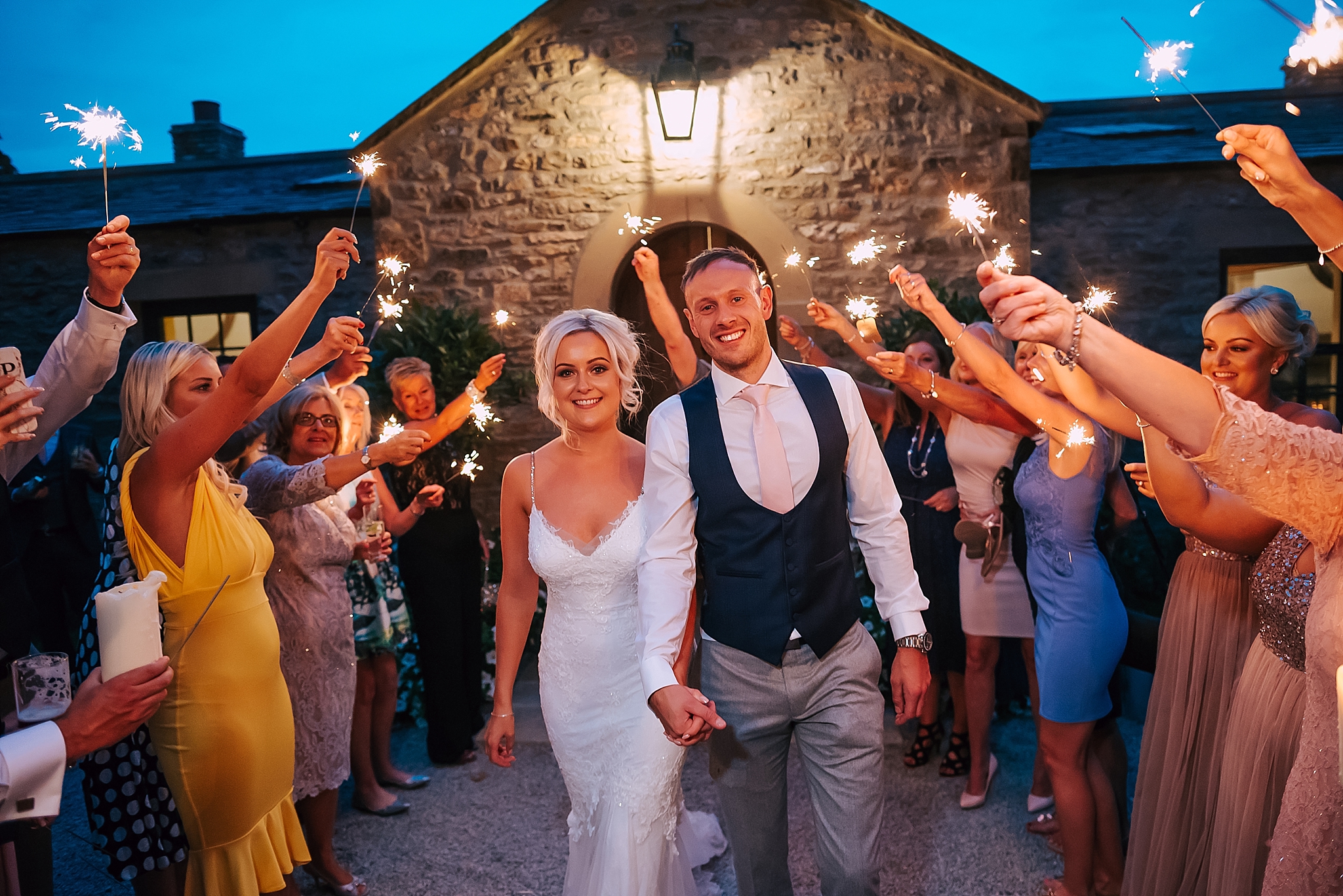 wedding couple do sparkler walk at fig house