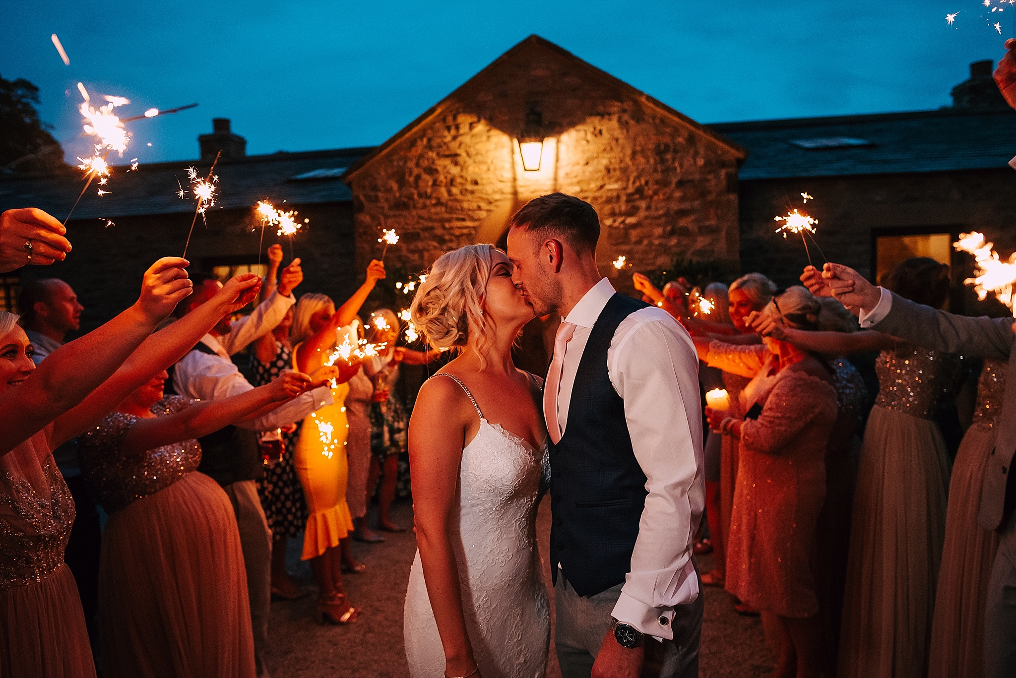 wedding couple with sparklers outside the fig house