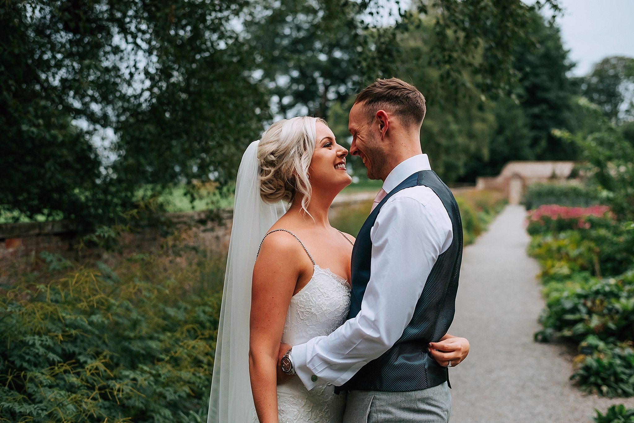 bride and groom in kitchen garden at the fig house