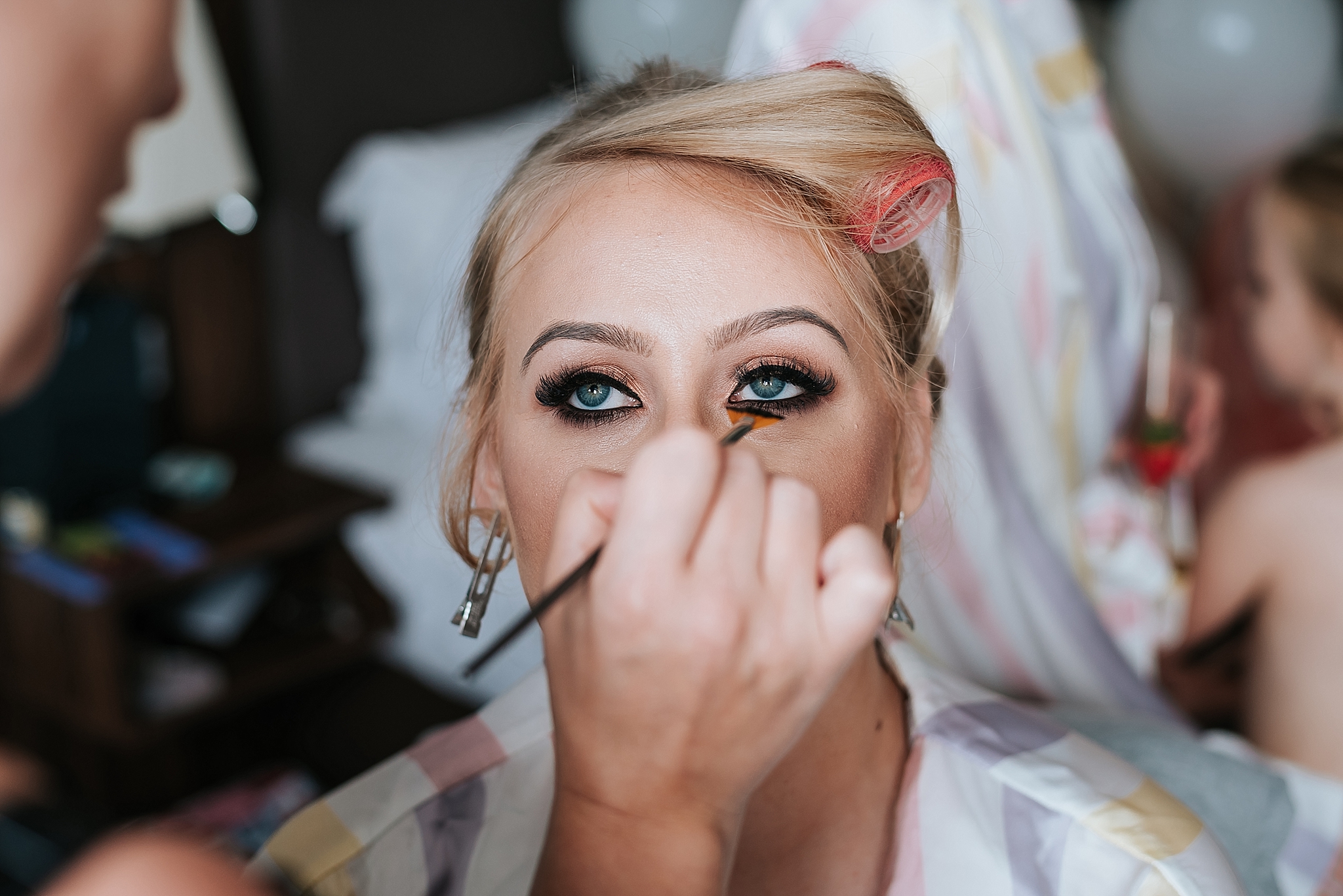 bride having make up done for wedding 