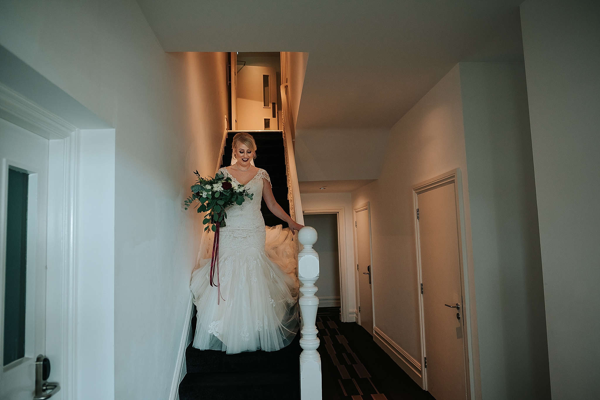 bride walking down the stairs at the grand hotel in lytham st annes 