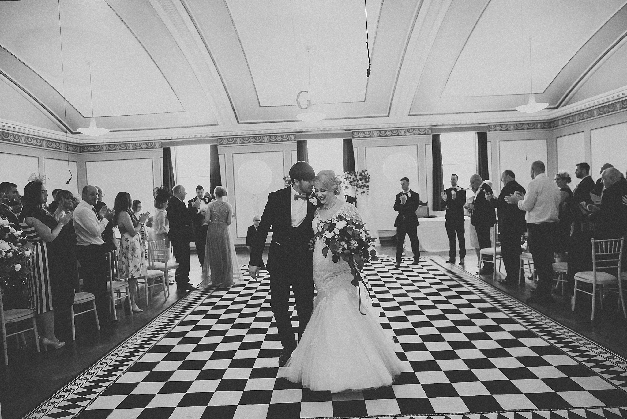 wedding couple walk out of ceremony room at st annes palace 