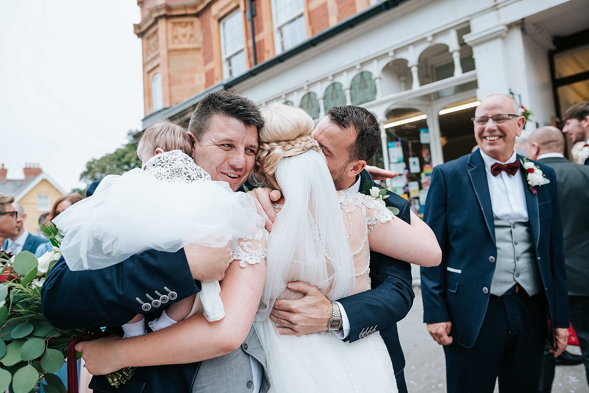 bride hugs her family after wedding celebration at st annes palace 