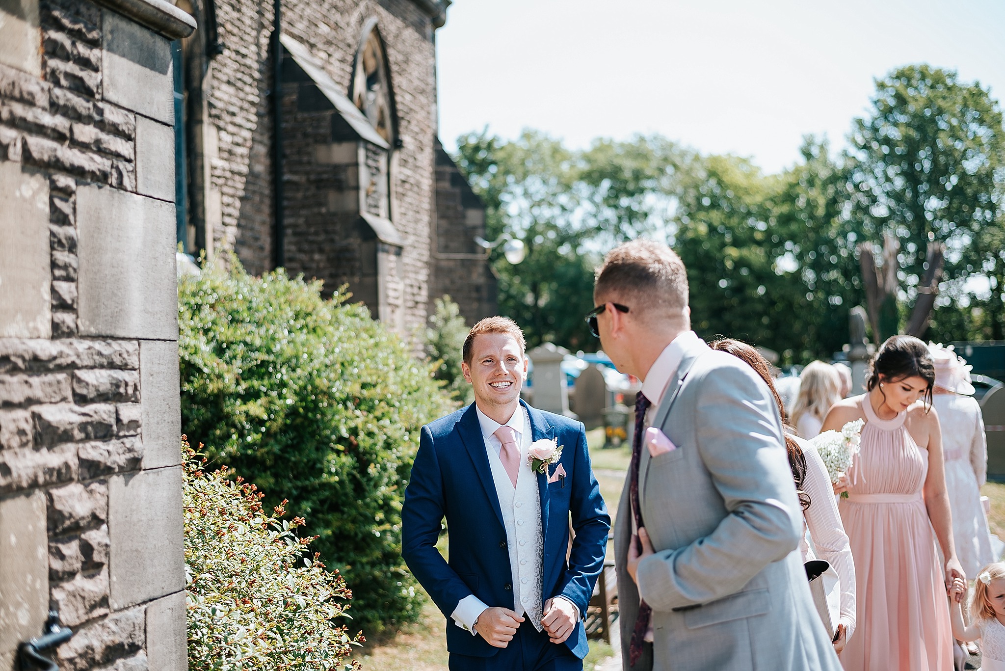 groom chatting to guests at wedding 