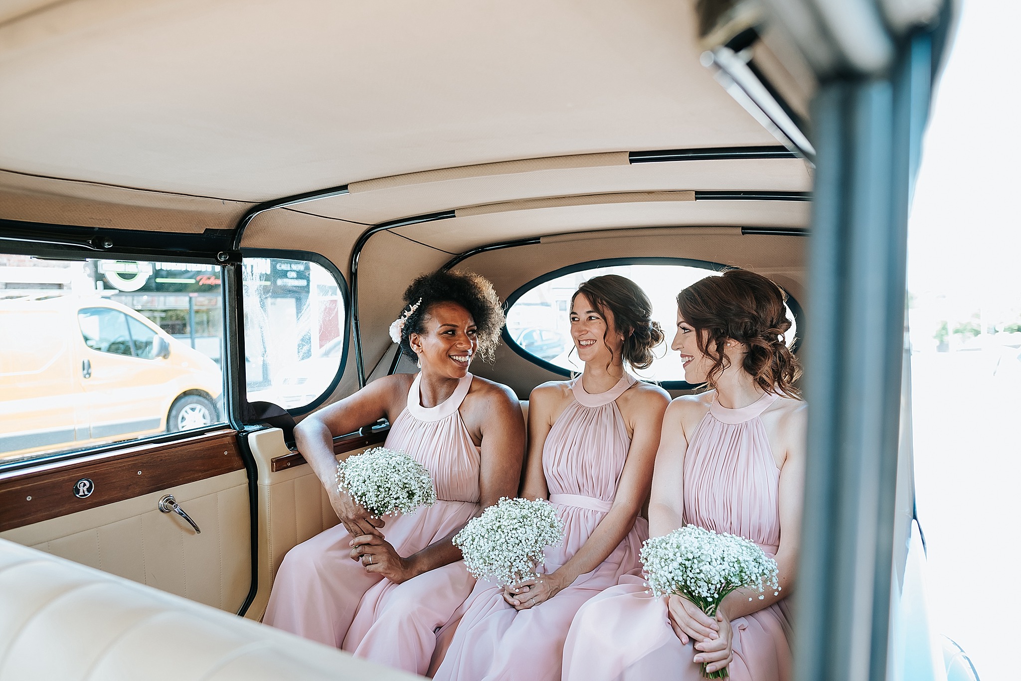 bridesmaids in wedding car 