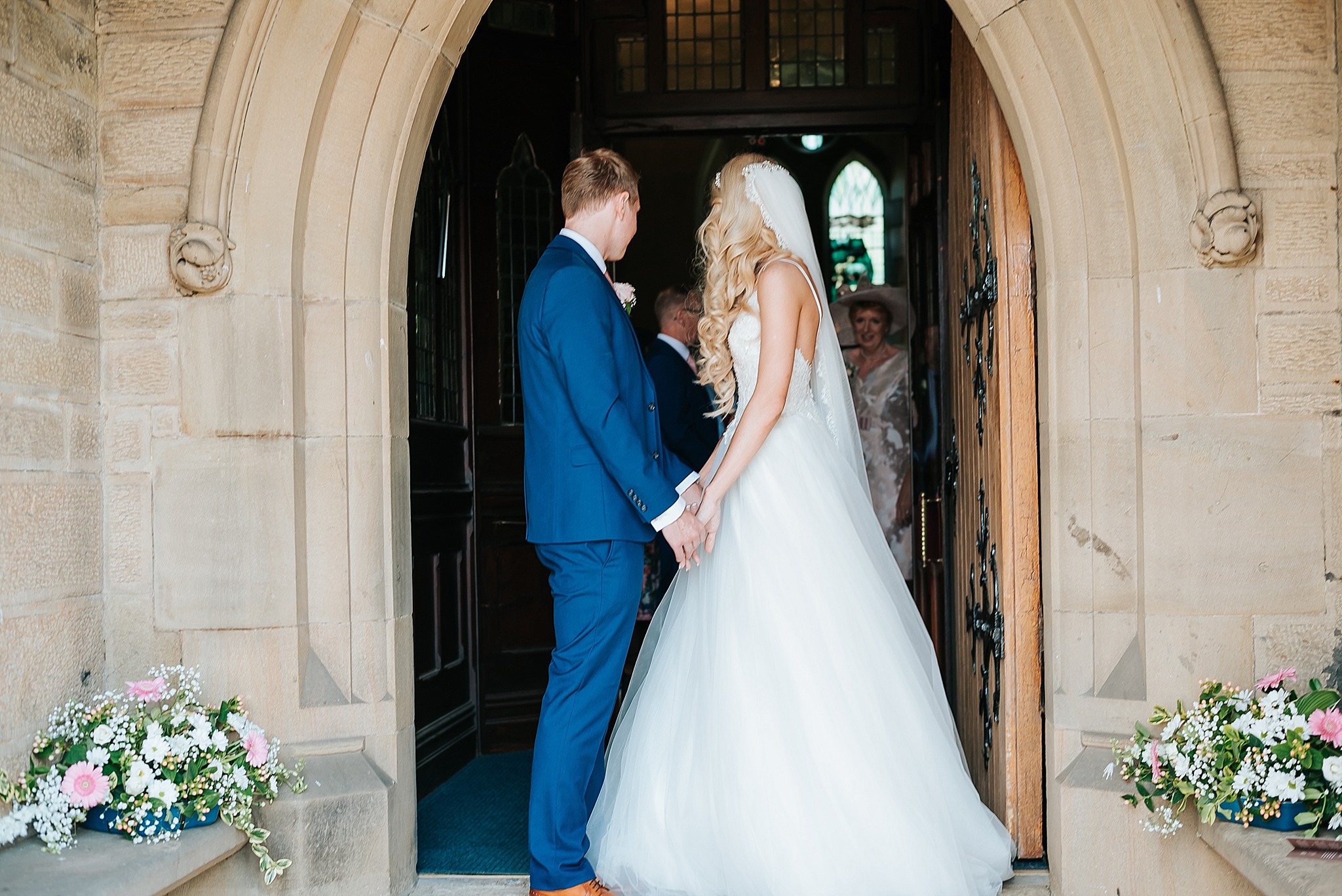 bride and groom leave church in preston