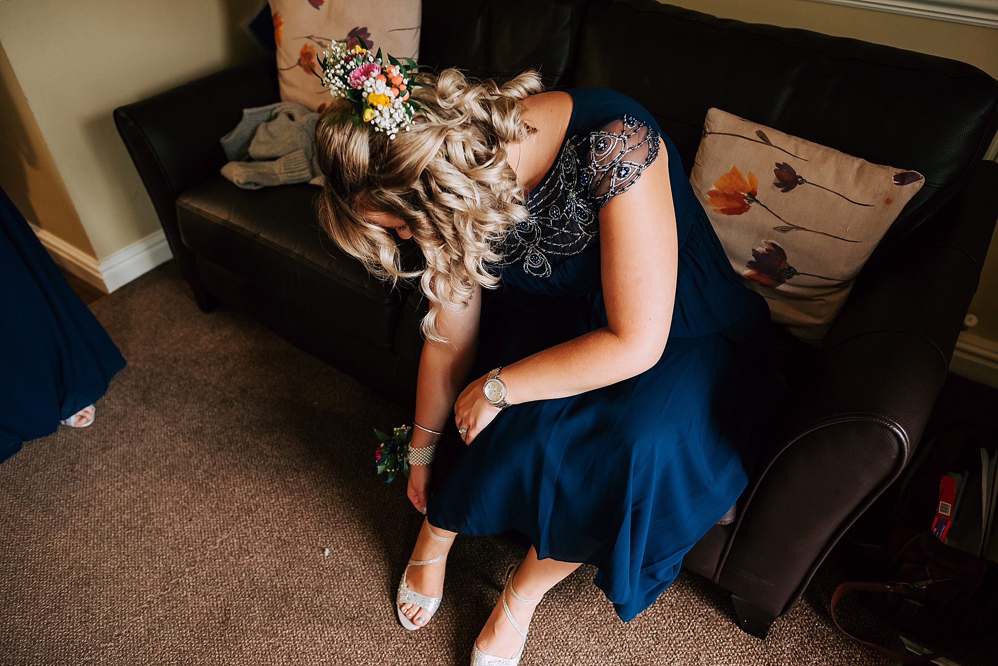 bridesmaid puts shoes on for summer wedding