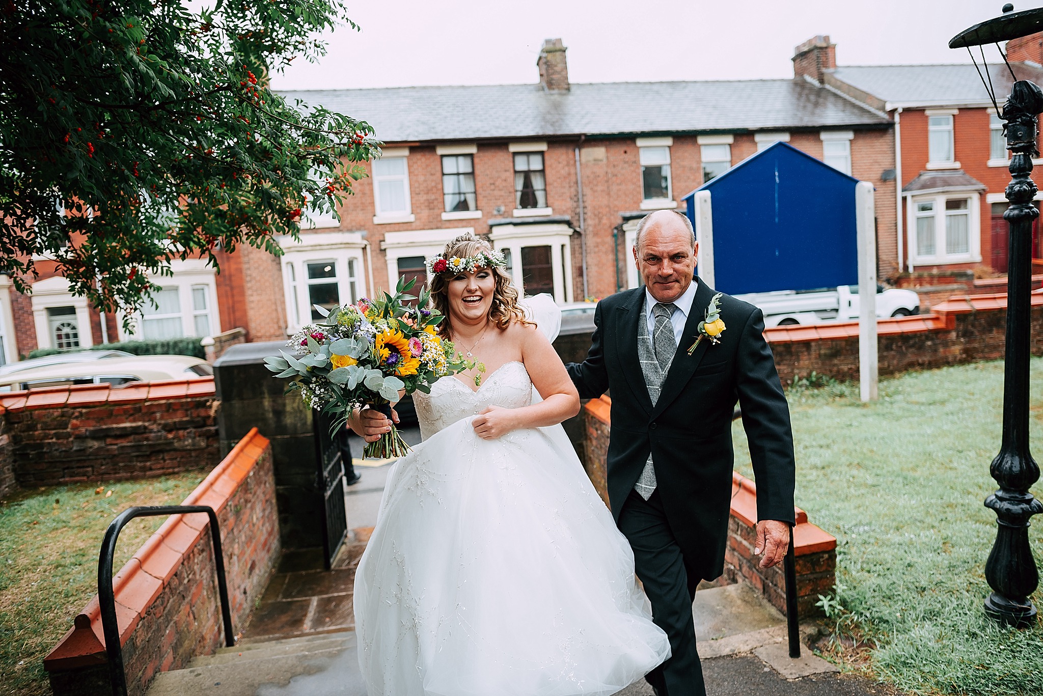 bride and her dad walk up path at christ church wesham