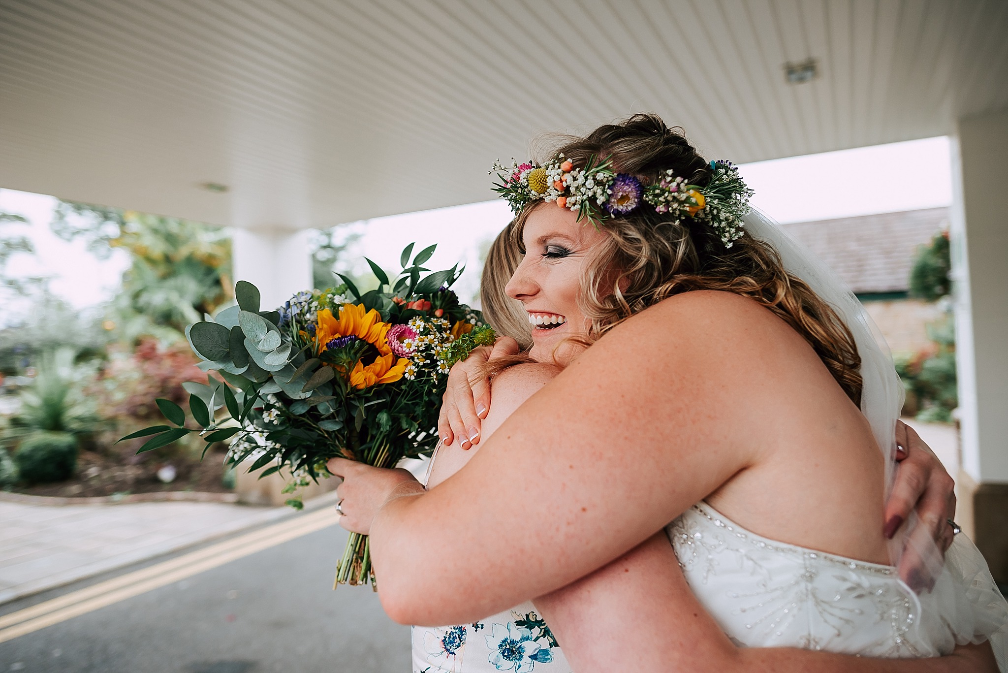 bride greeting a guest at a summer wedding