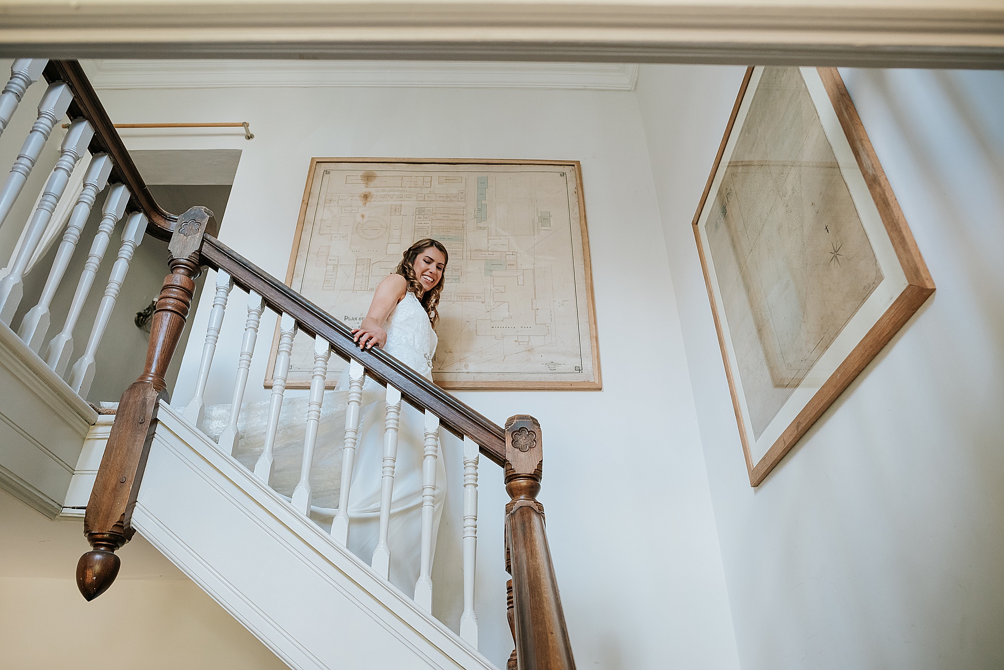 bride walks down main staircase at wyresdale park