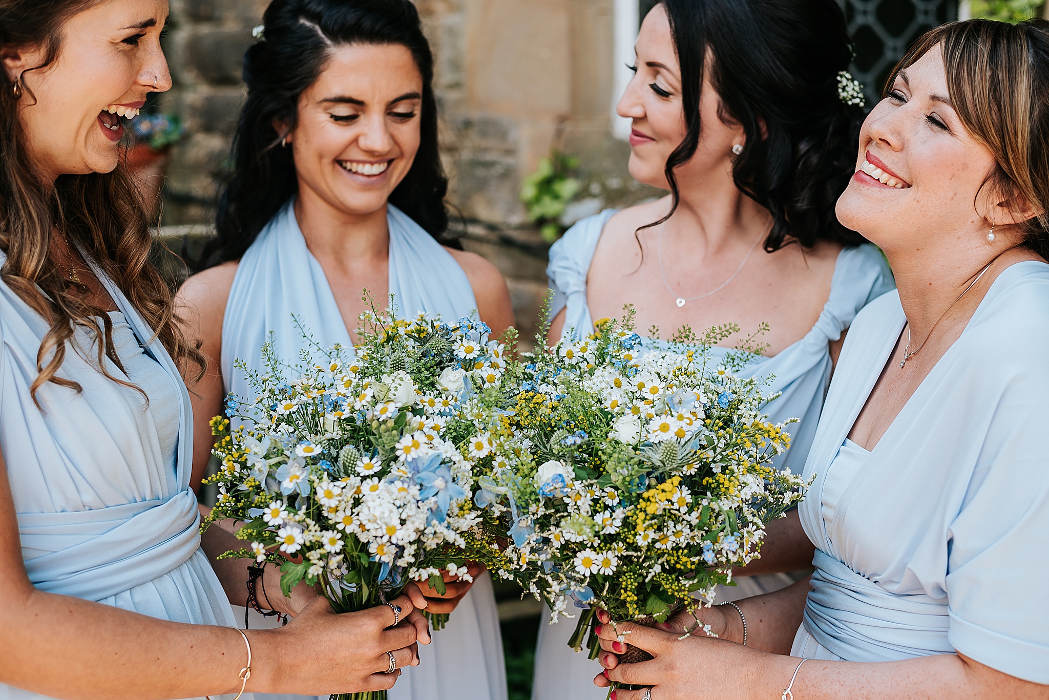 bridesmaids in blue dresses with spring blue and yellow flowers