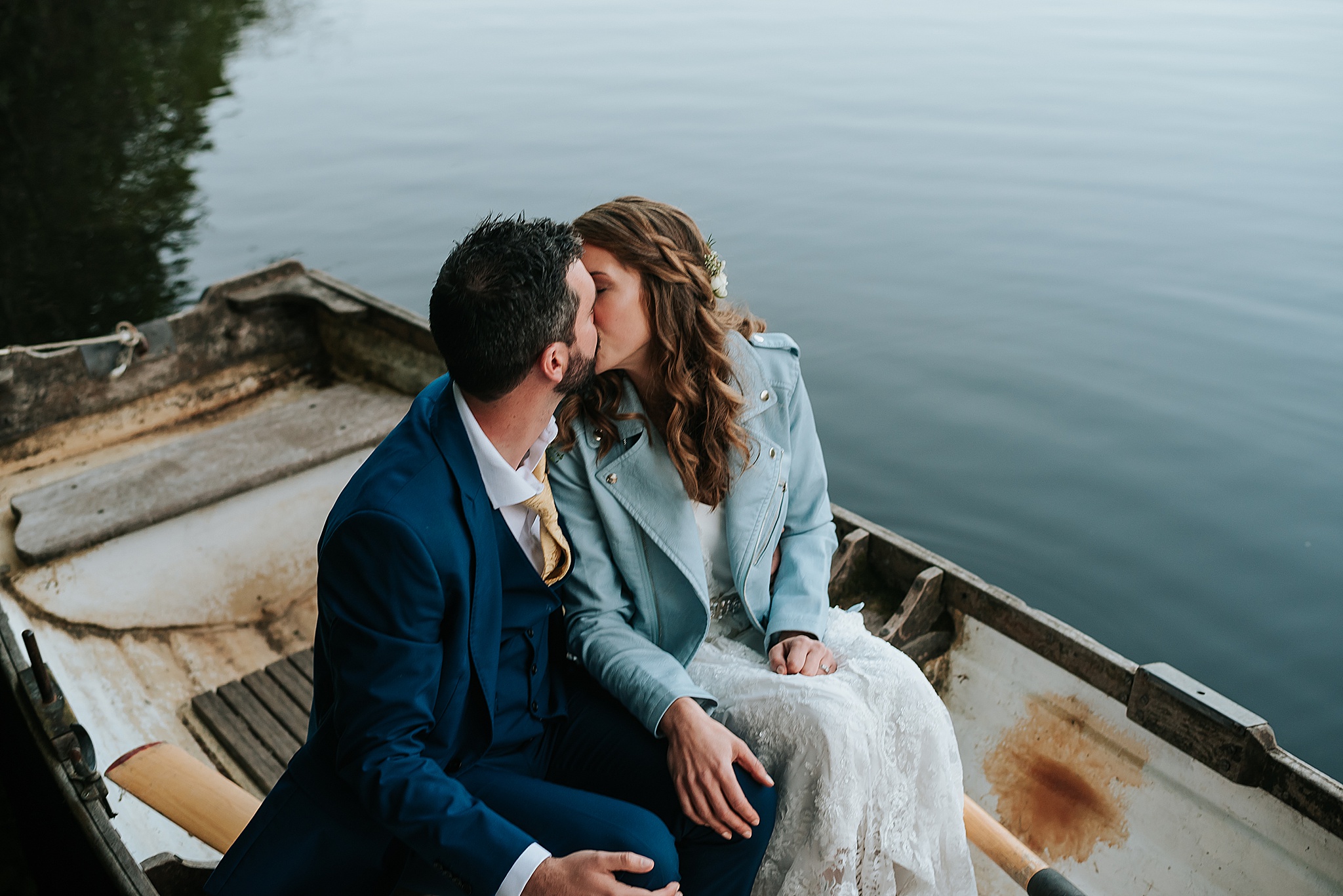 wedding couple on the boat on the lake at qyresdale park