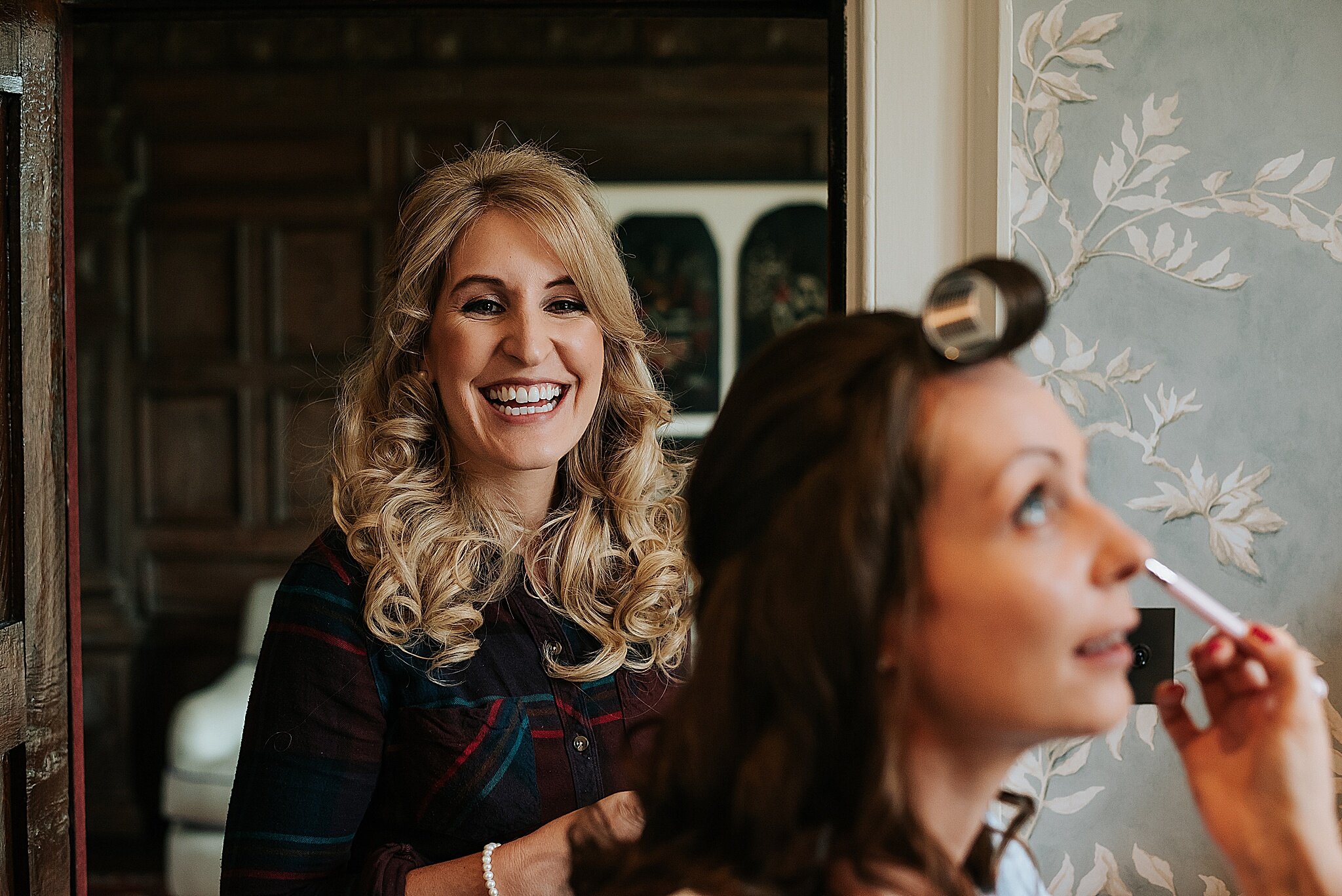 bridesmaid laughing before wedding at dorfold hall in cheshire