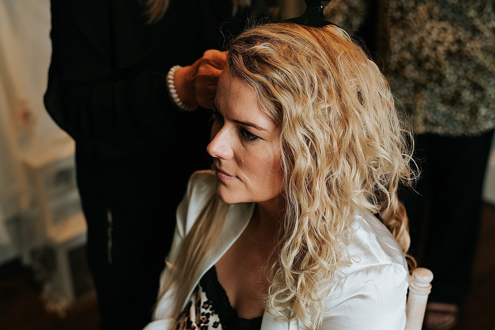 bride has hair done before wedding at cheshire wedding venue