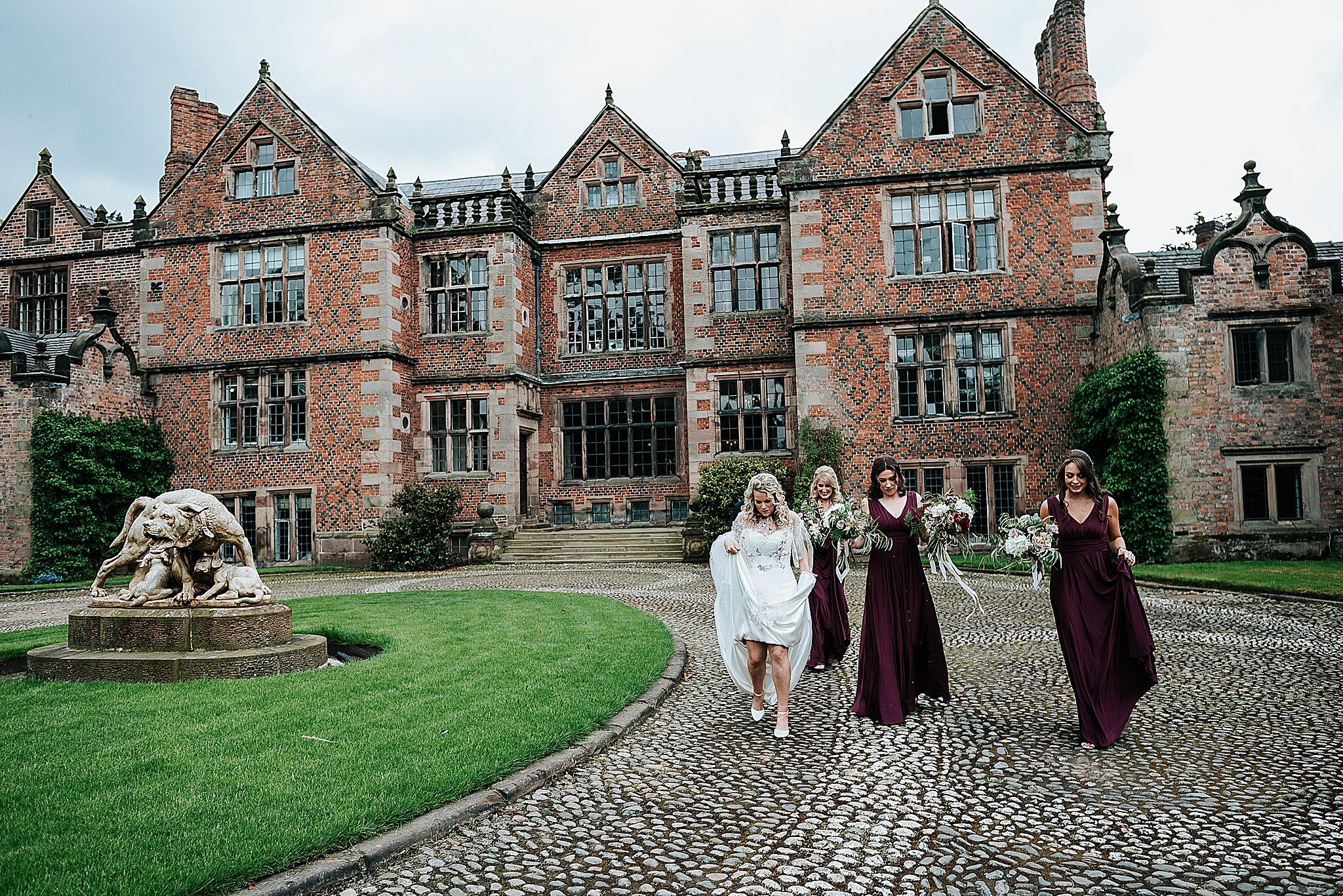 bride walks in front of dorfold hall in cheshire 