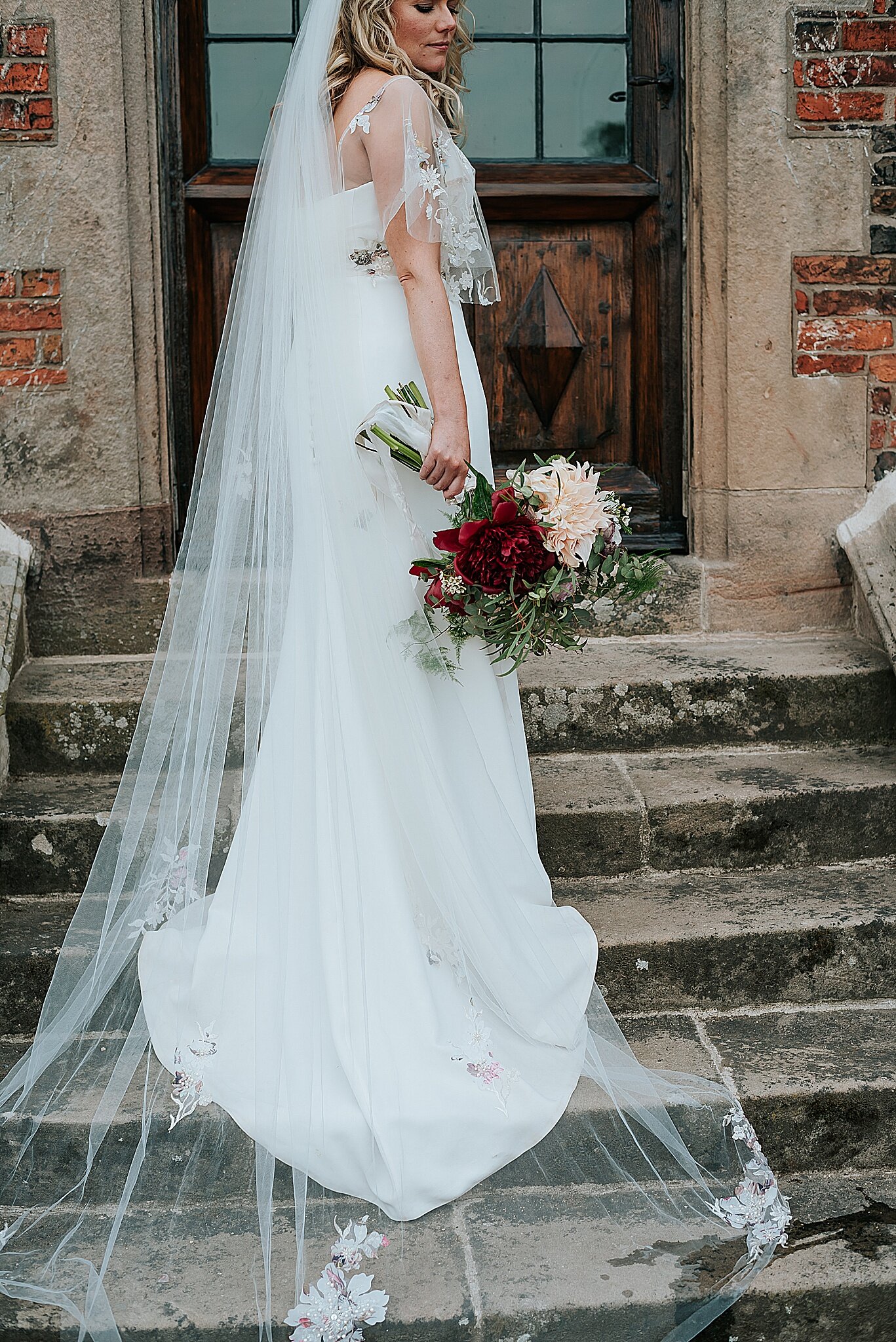 bride on stairs of dorfold hall 