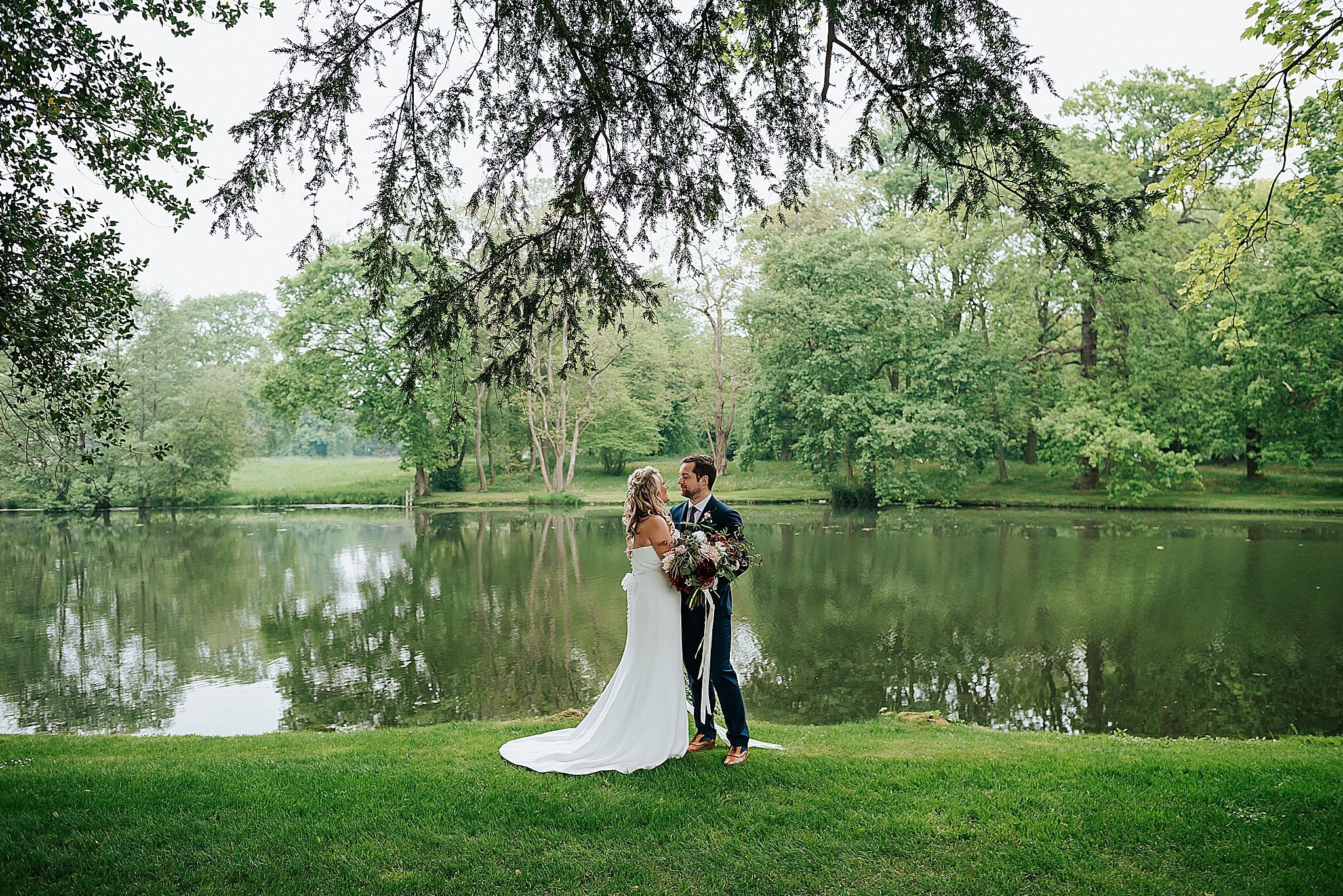 bride and groom by the lake at dorfold hall 