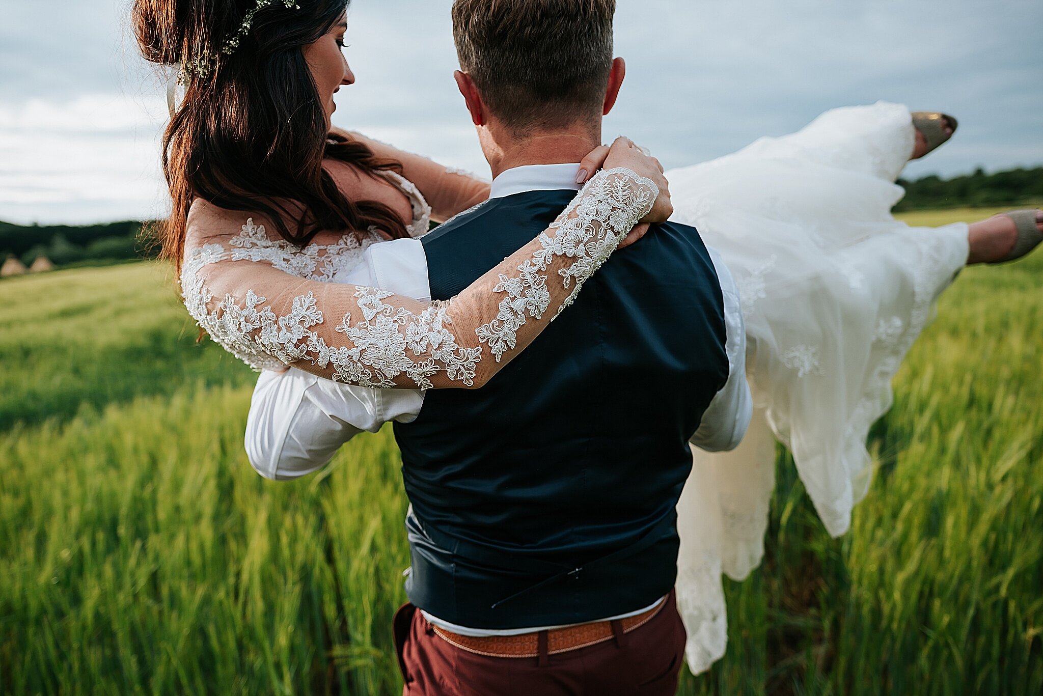 couple in field at tipi wedding 
