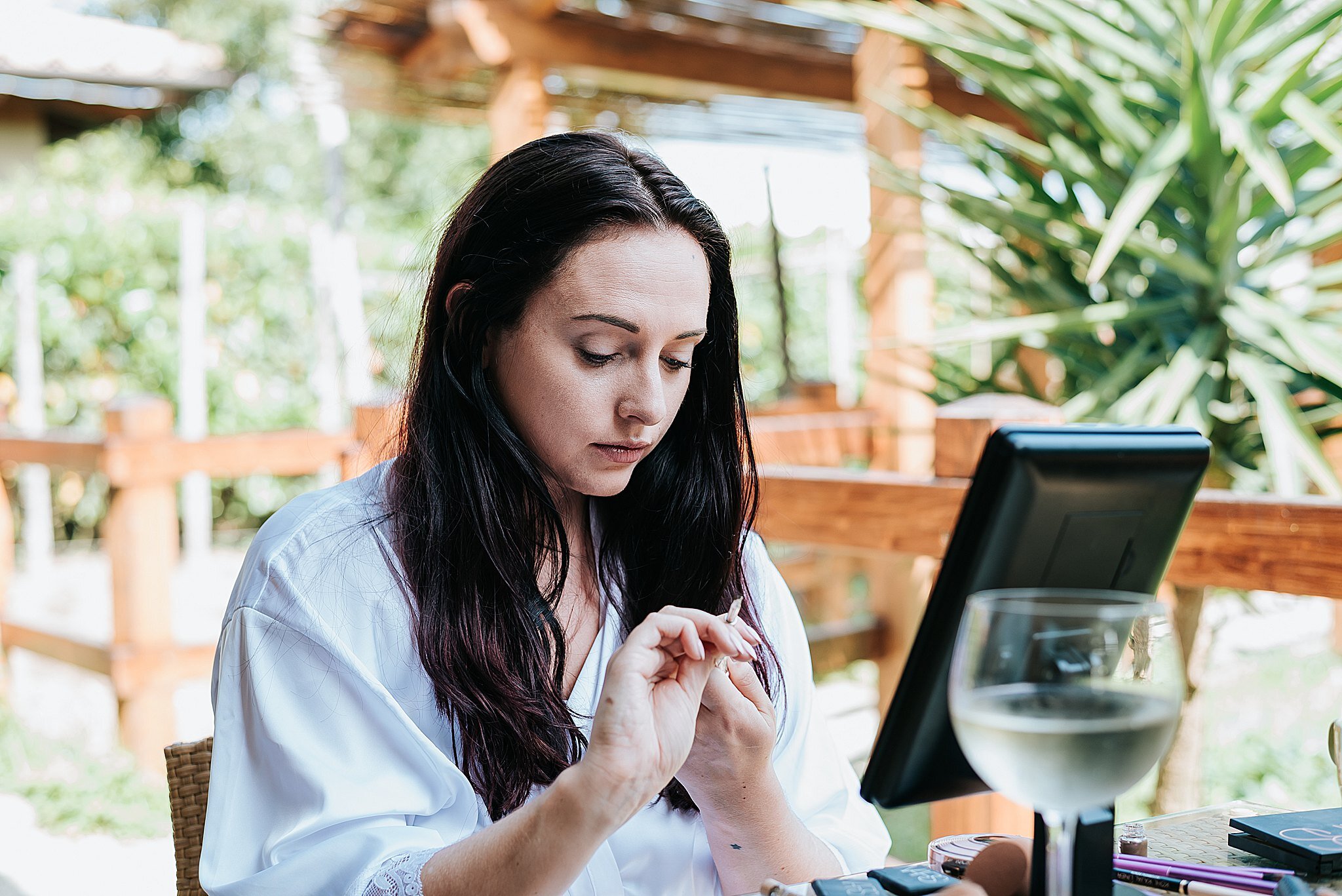 bride doing make up before wedding 